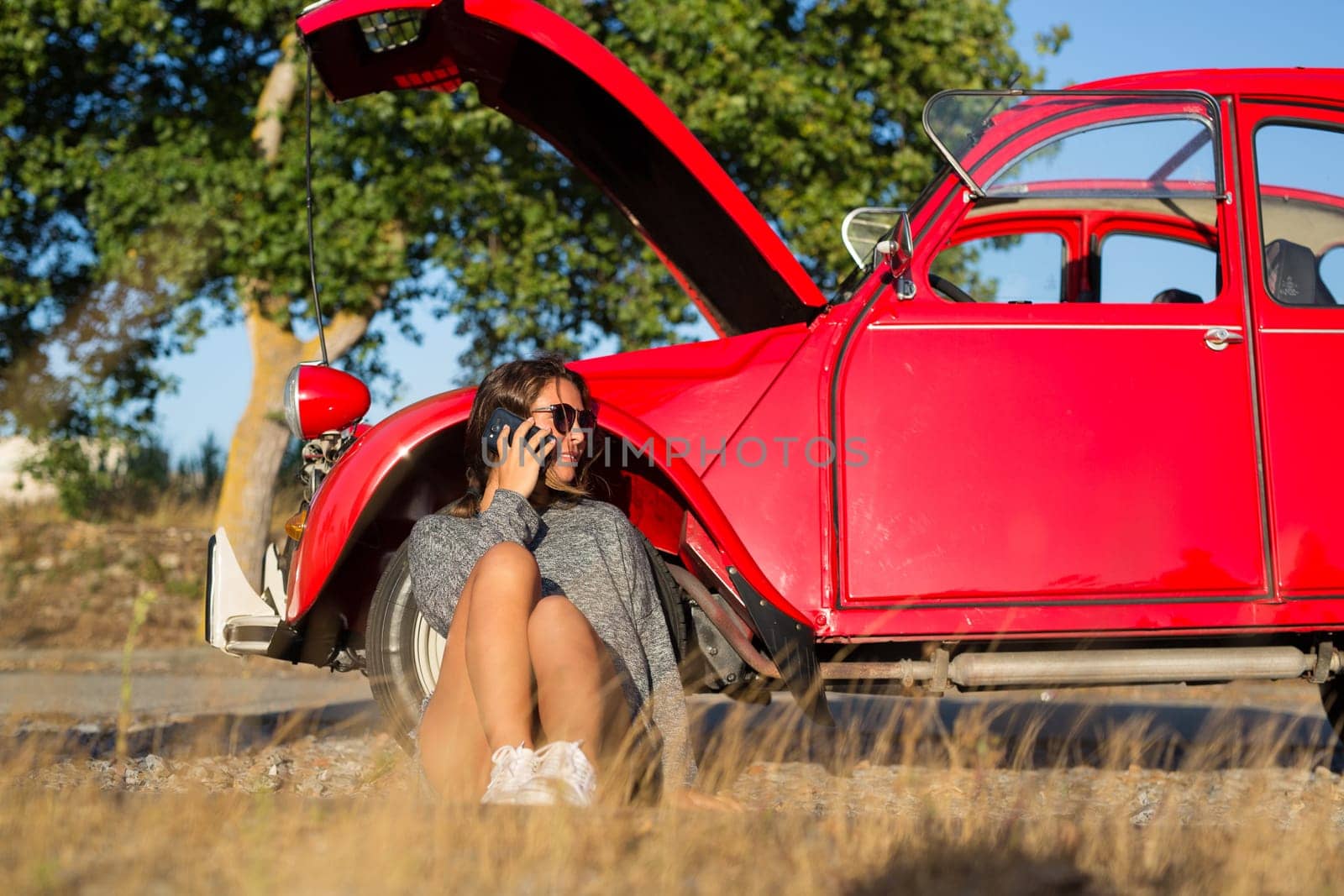 Woman on a roadtrip having a problem with her old car