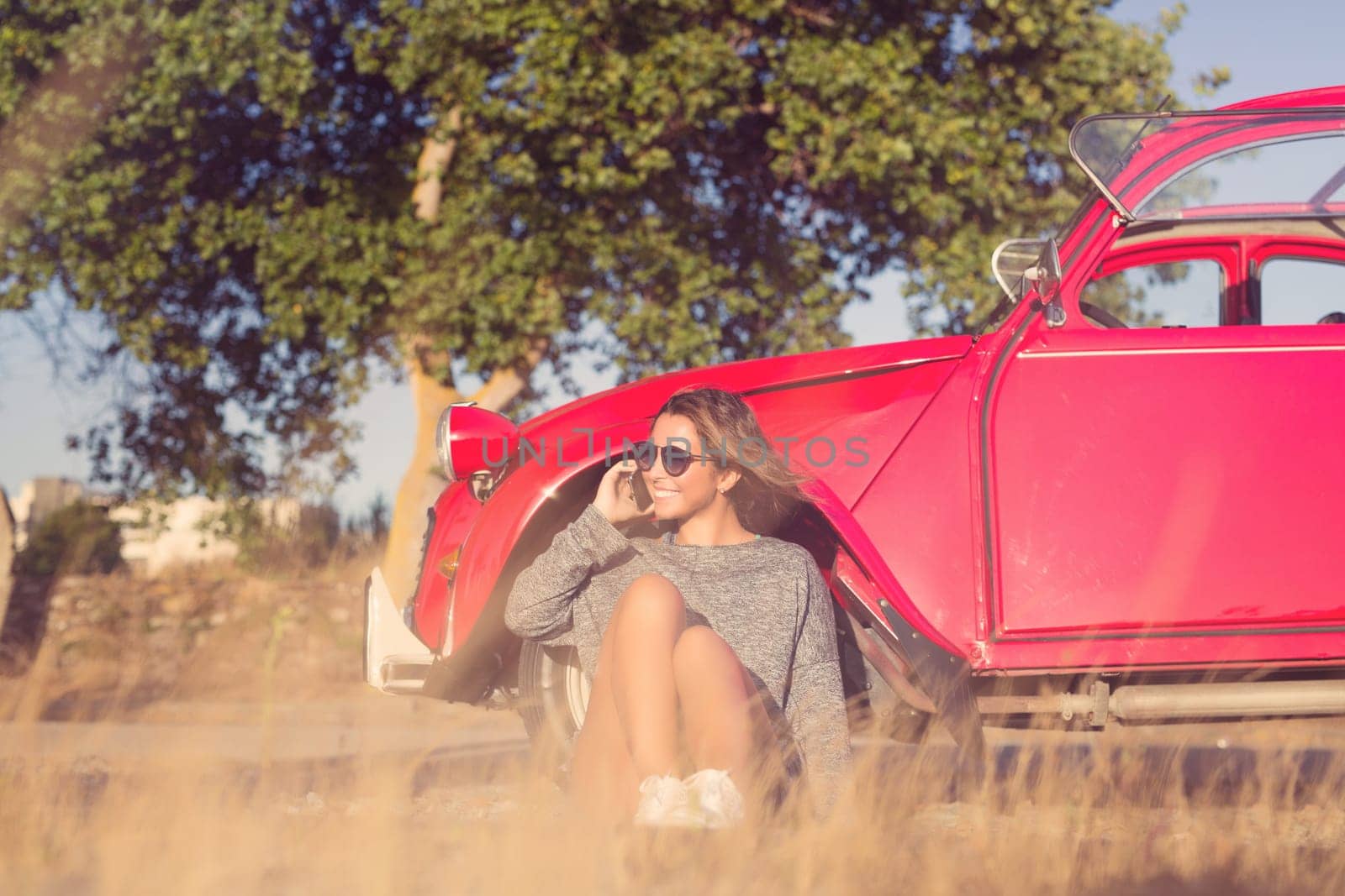 Young woman resting at car trip by the countryside