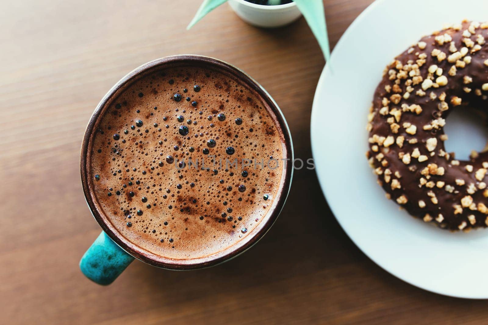 Donuts on the white plate and coffee on the wooden table. High quality photo