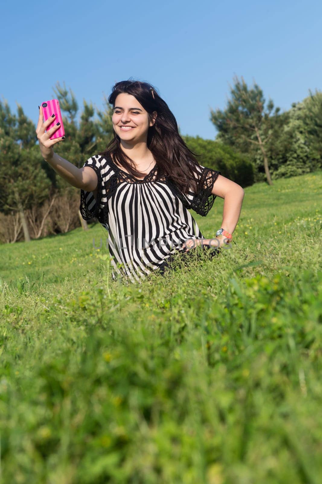 A beautiful young woman relaxing at the city park