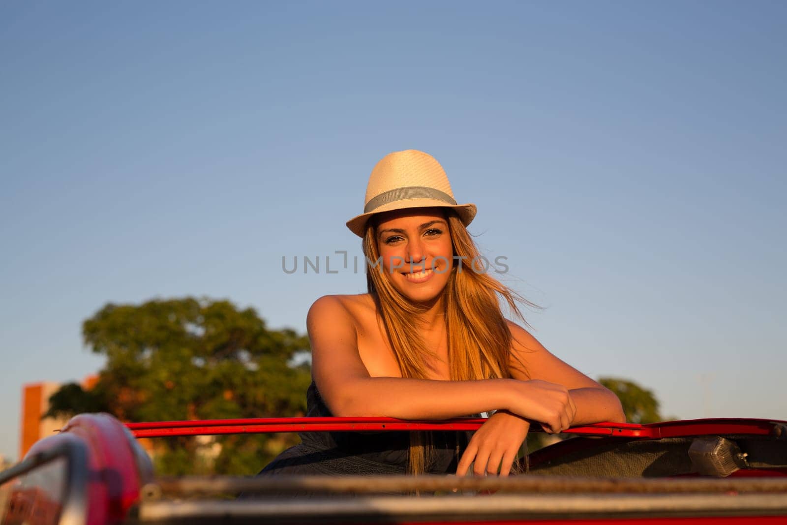 Woman going on a roadtrip in her convertible car