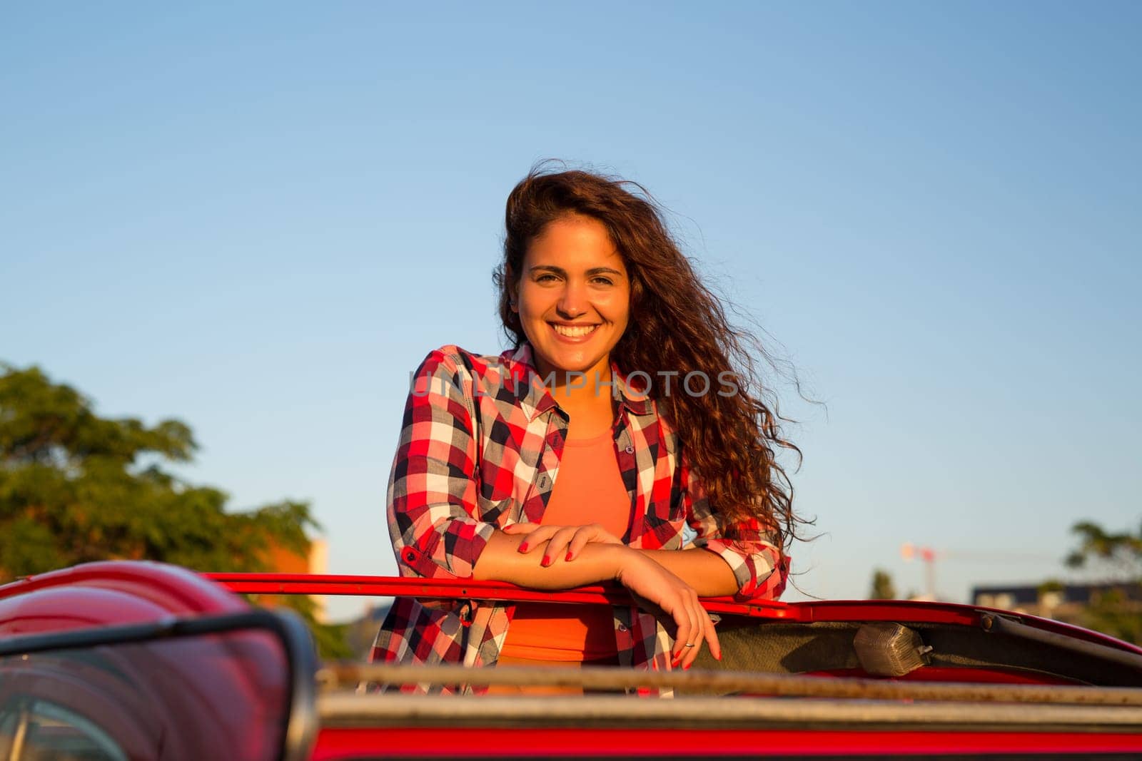 Woman going on a roadtrip in her convertible car