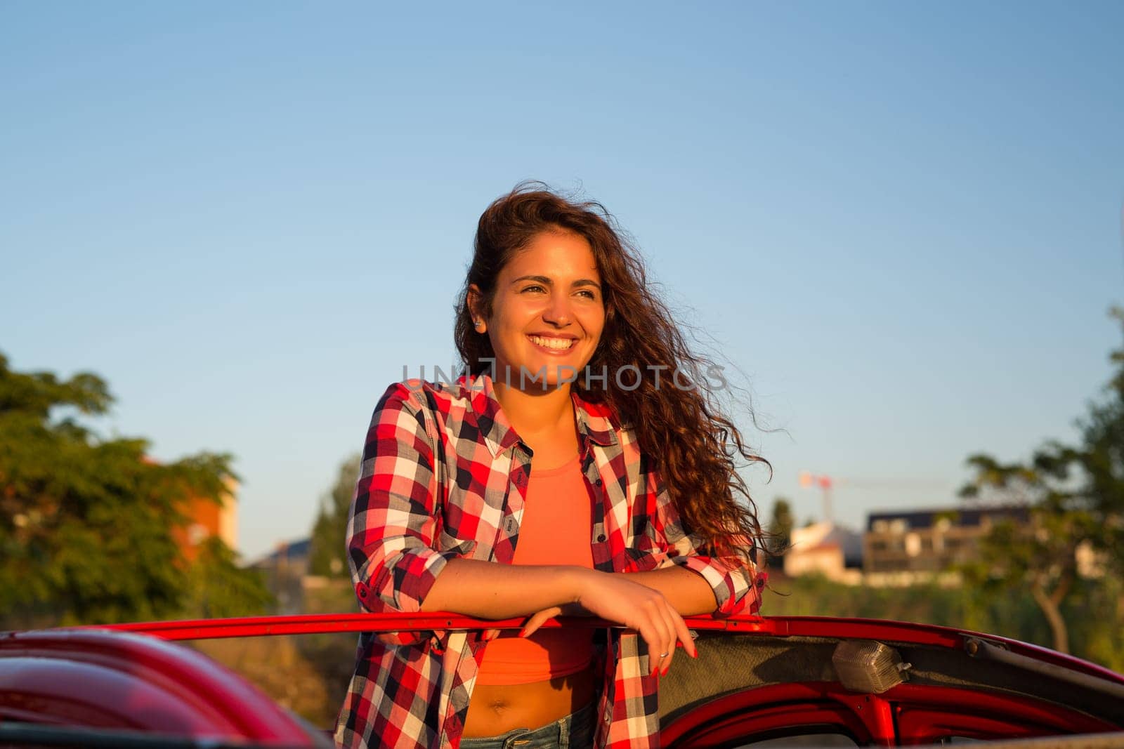 Woman going on a roadtrip in her convertible car