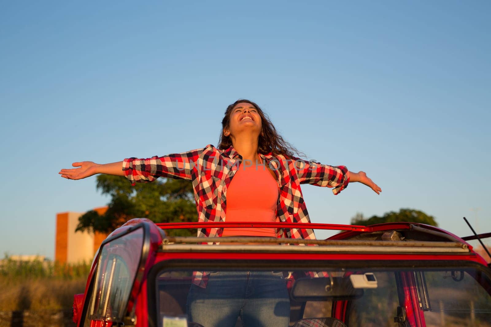 Woman going on a roadtrip in her convertible car