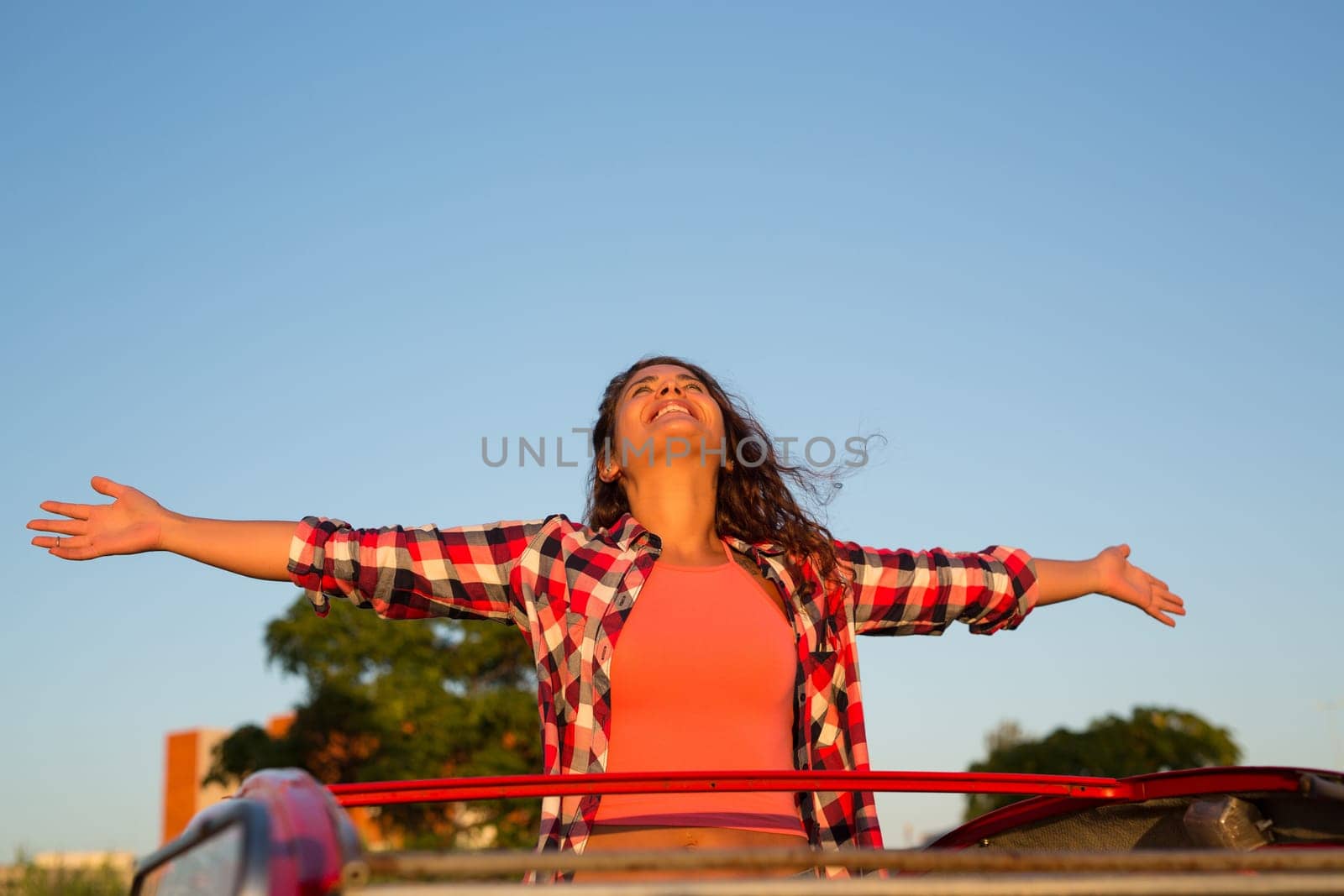 Woman going on a roadtrip in her convertible car