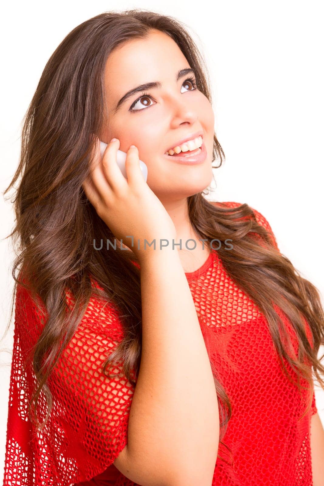 Teenager with cellphone, posing over a white background