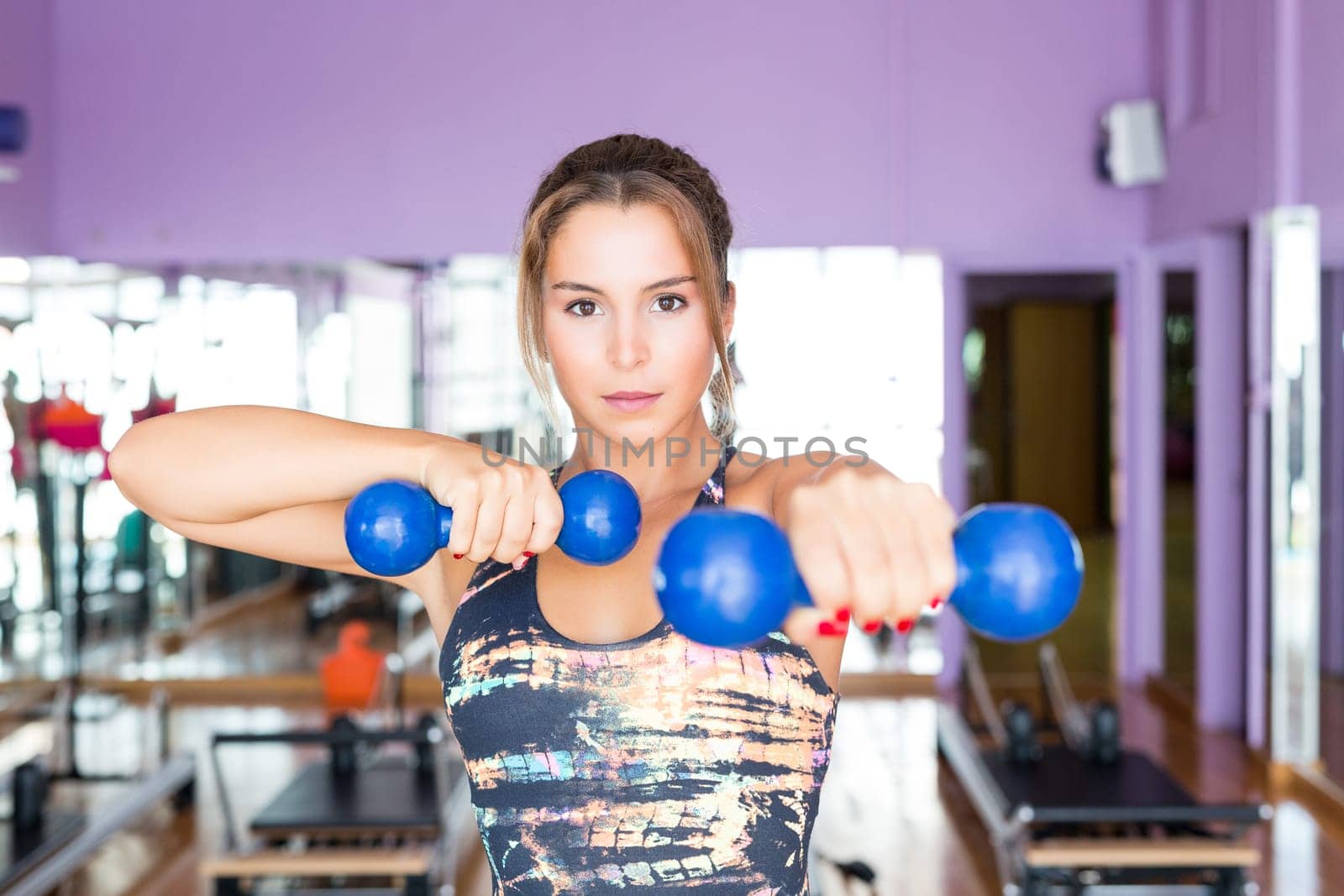Young woman getting into shape at the gym