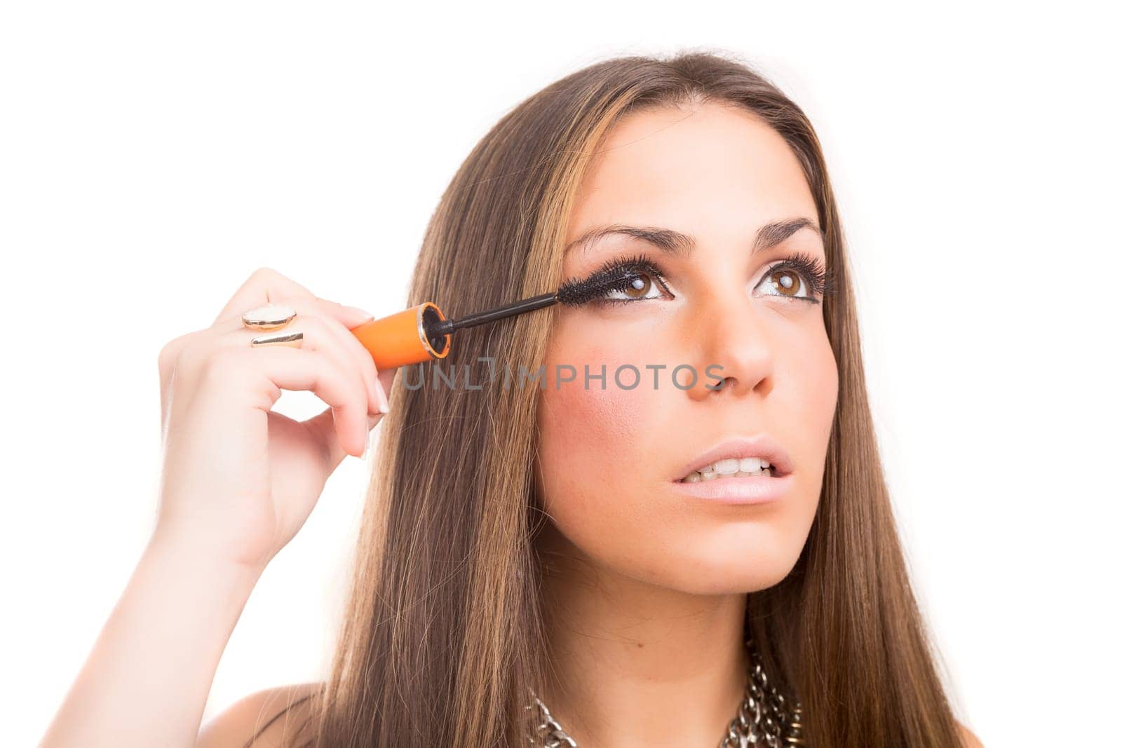 Beautiful young woman applying makeup