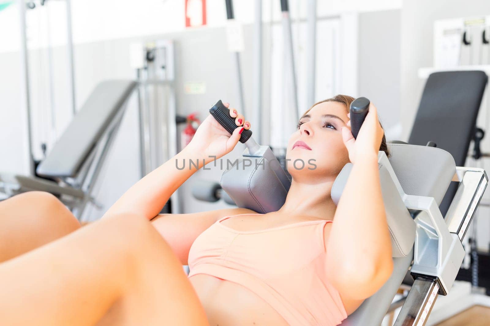Young woman getting into shape at the gym