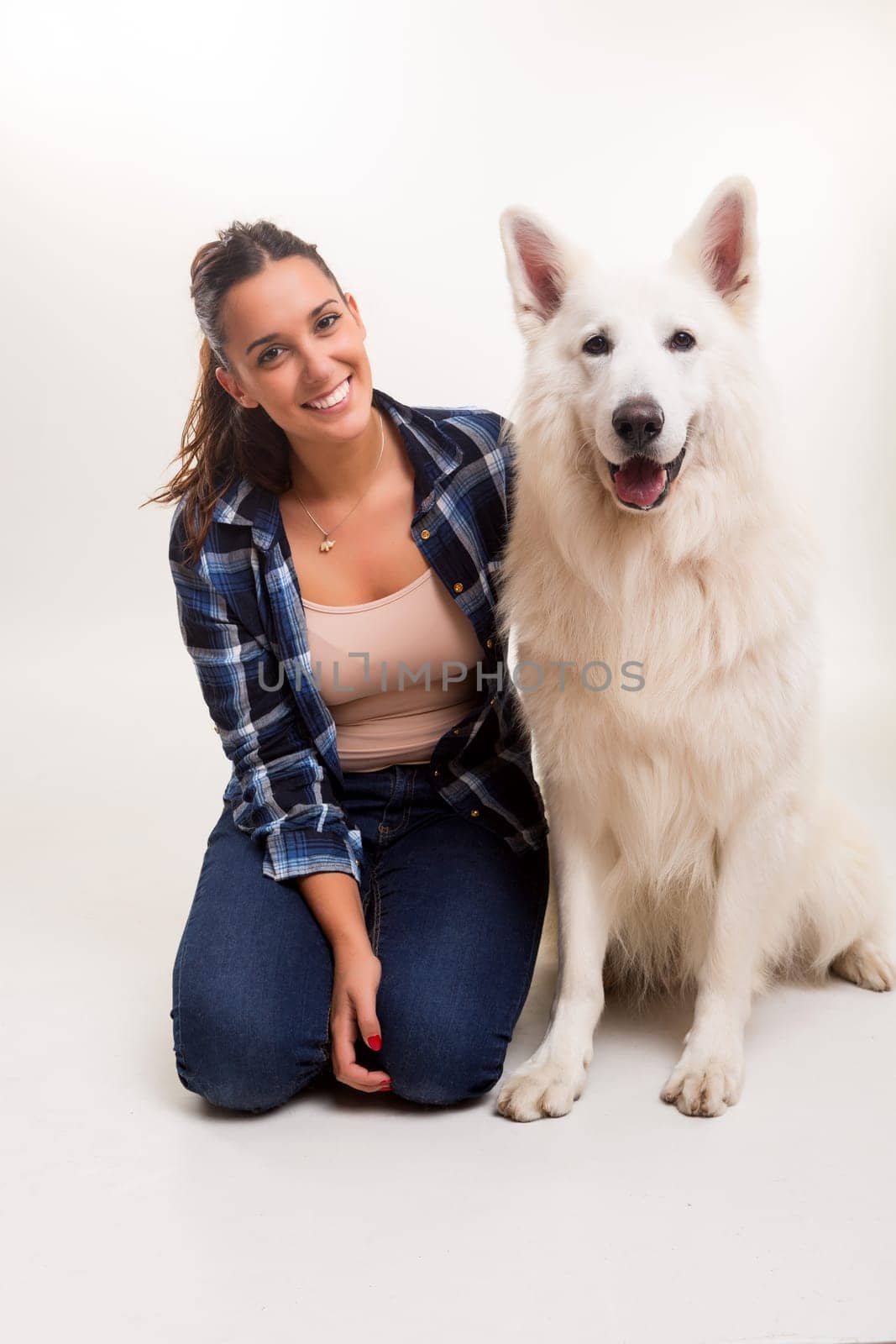 Young woman playing with her dog at the studio