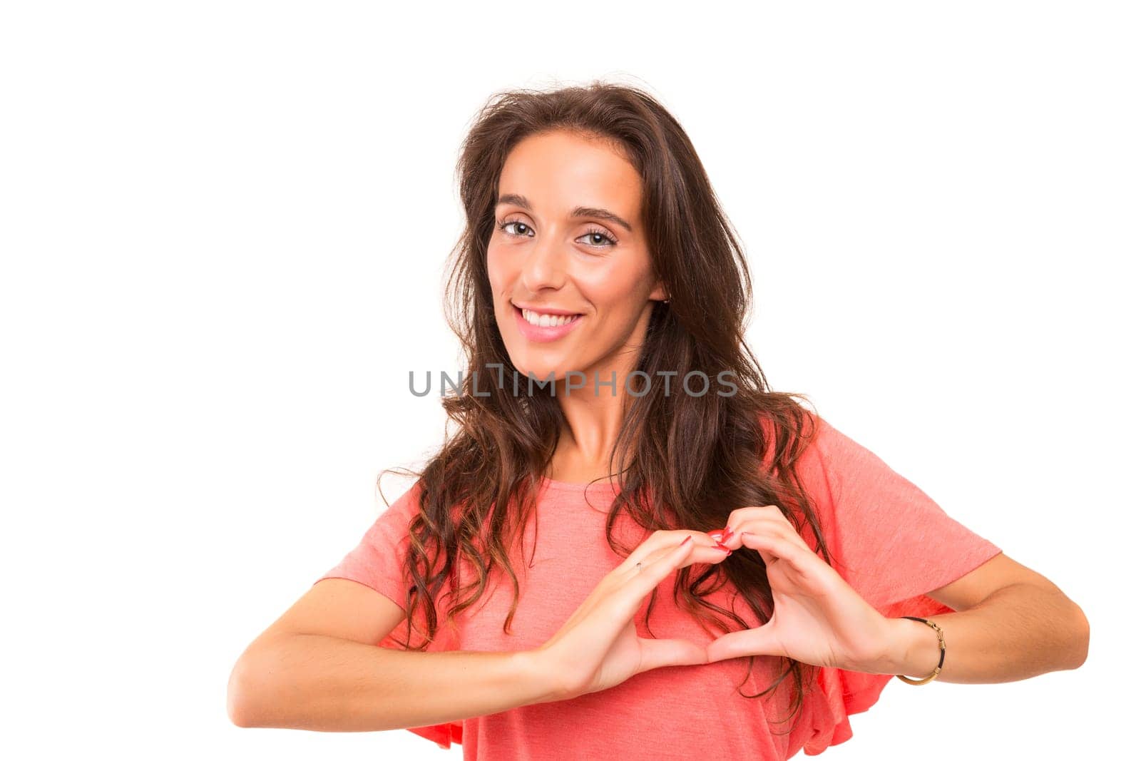 Beautiful woman making a heart shape with her hands, isolated over white background