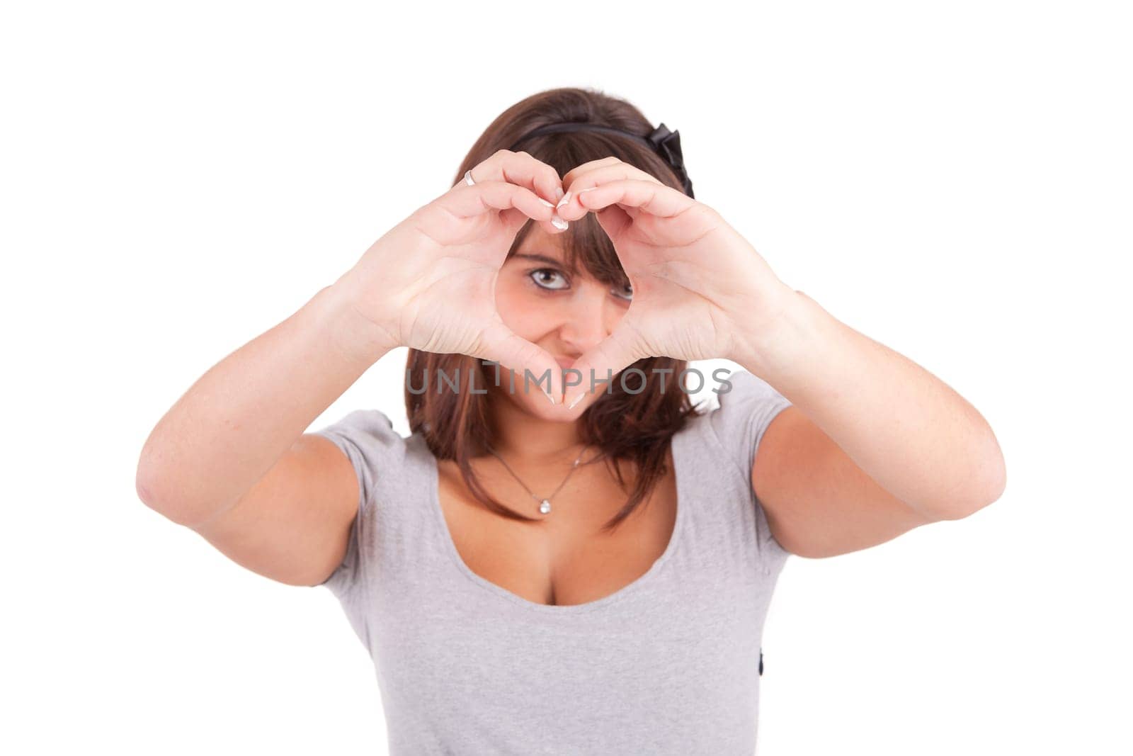 form of heart shaped by the hands of a young woman