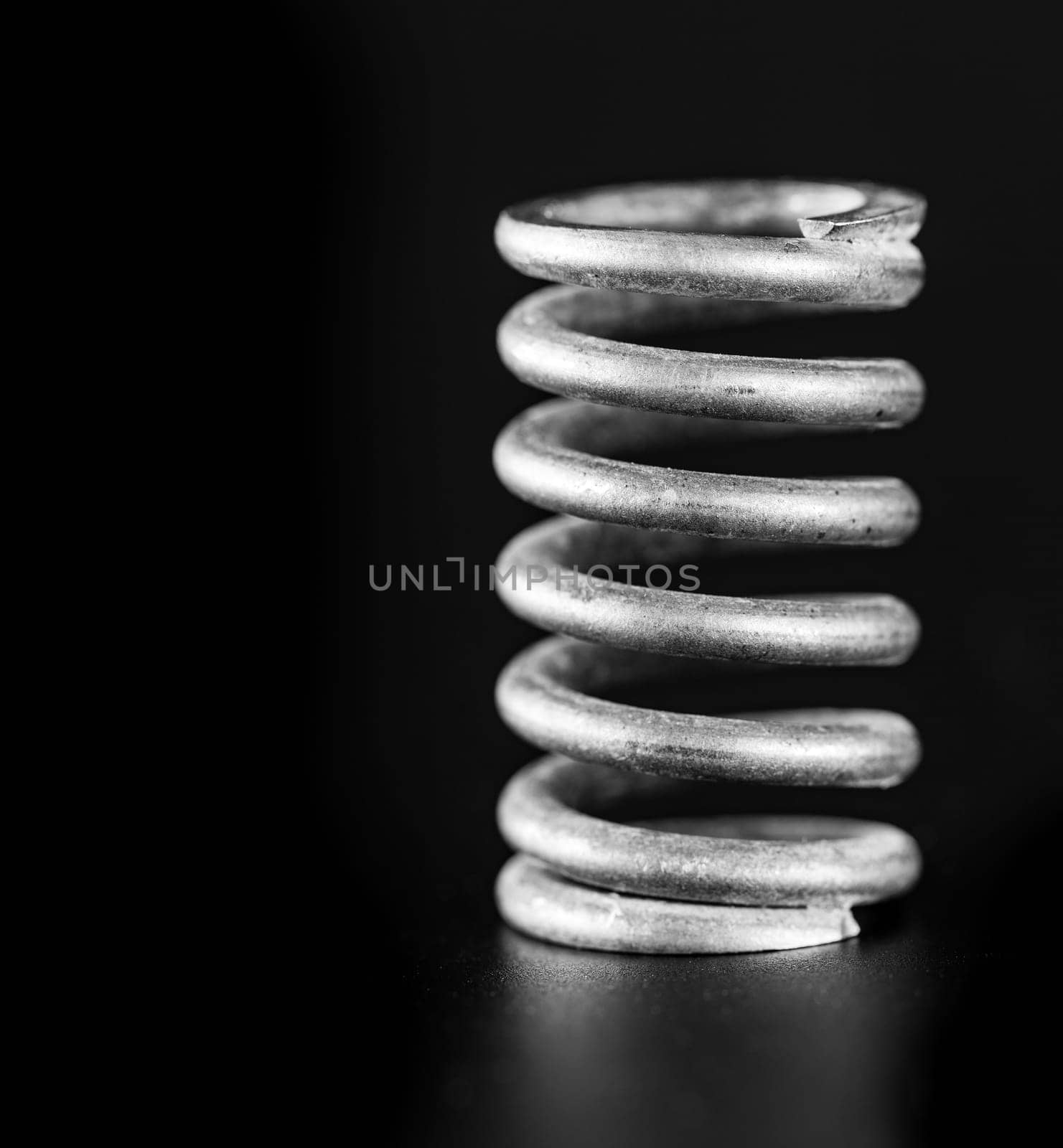 close up metal spring on black background