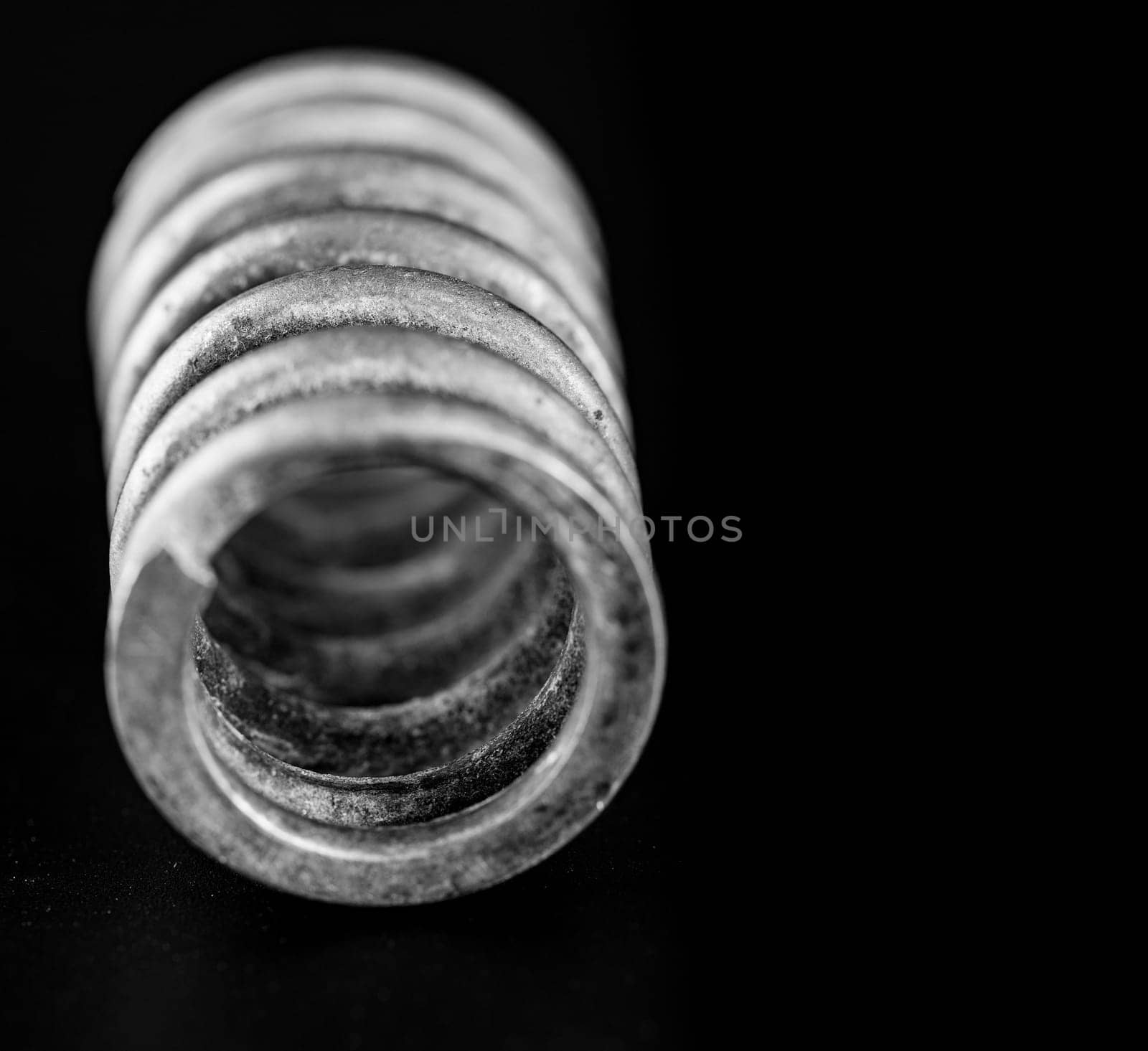 close up metal spring on black background