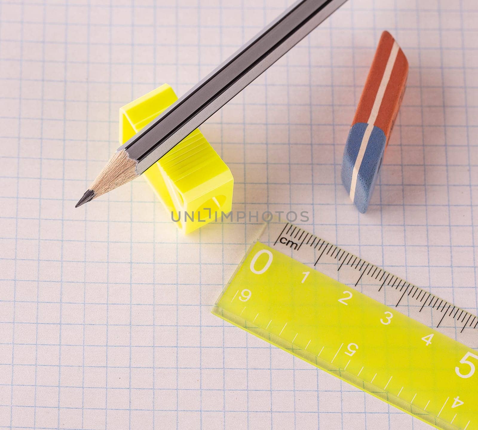 Pencils with pencil sharpener and eraser with ruler isolated on white background