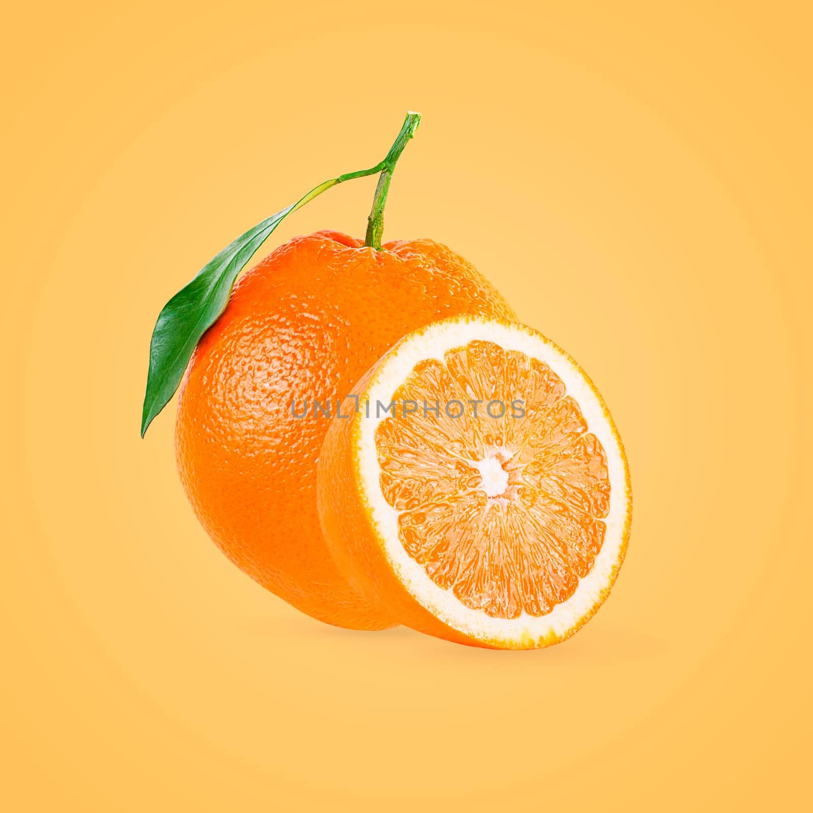 Minimal fruit concept. One whole and half orange fruits on bright yellow background with shadow. Design element. Full depth of field.