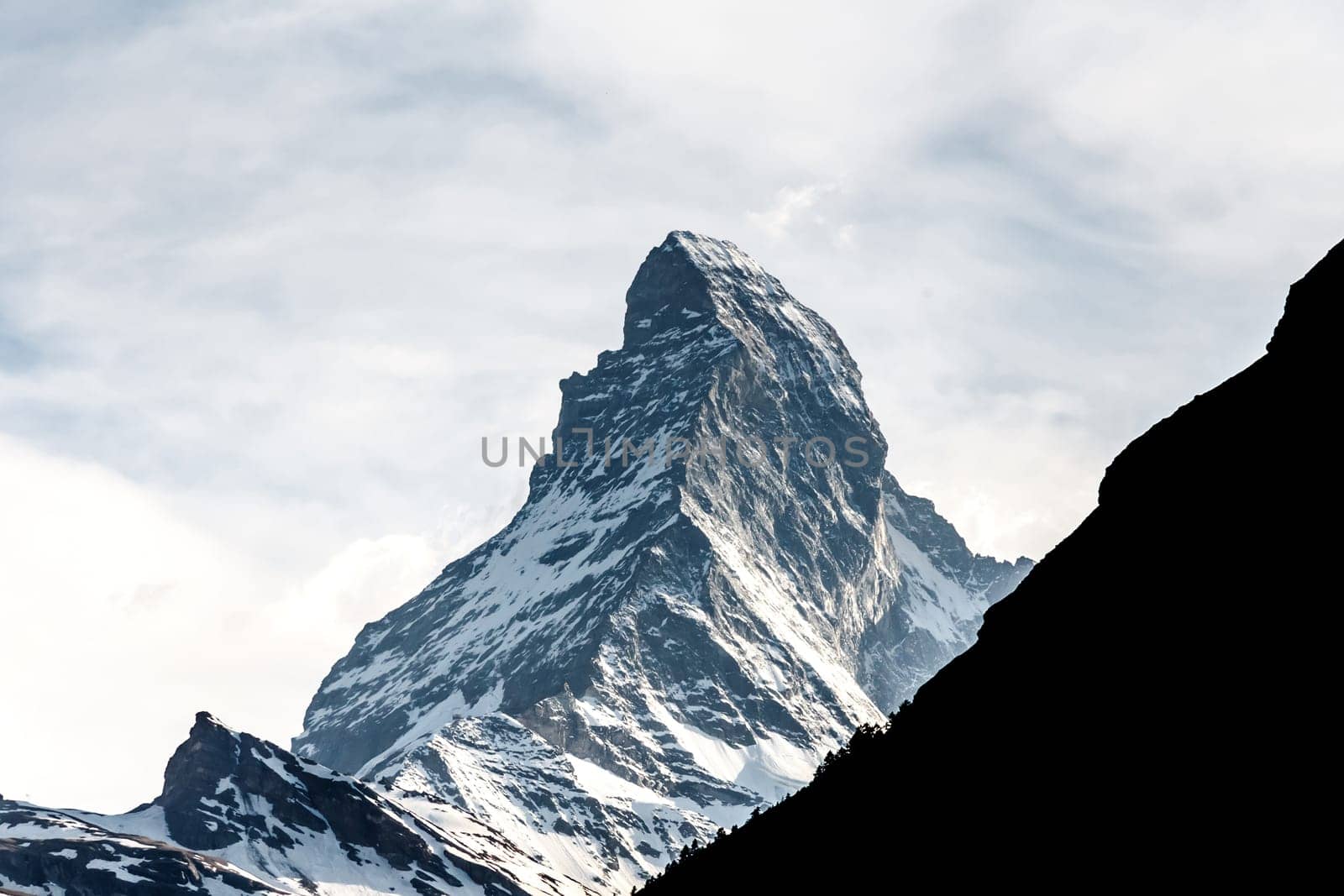 mountain Matterhorn, Alps, Zermatt, Switzerland with other silhouette mountain in front of Matterhorn