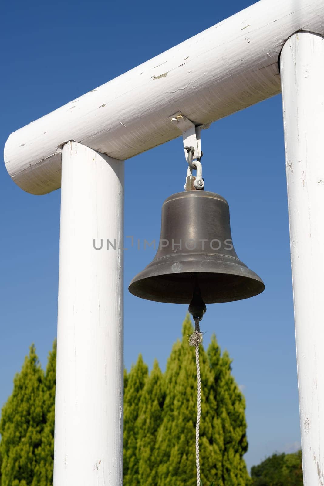 Alarm bell against a blue sky