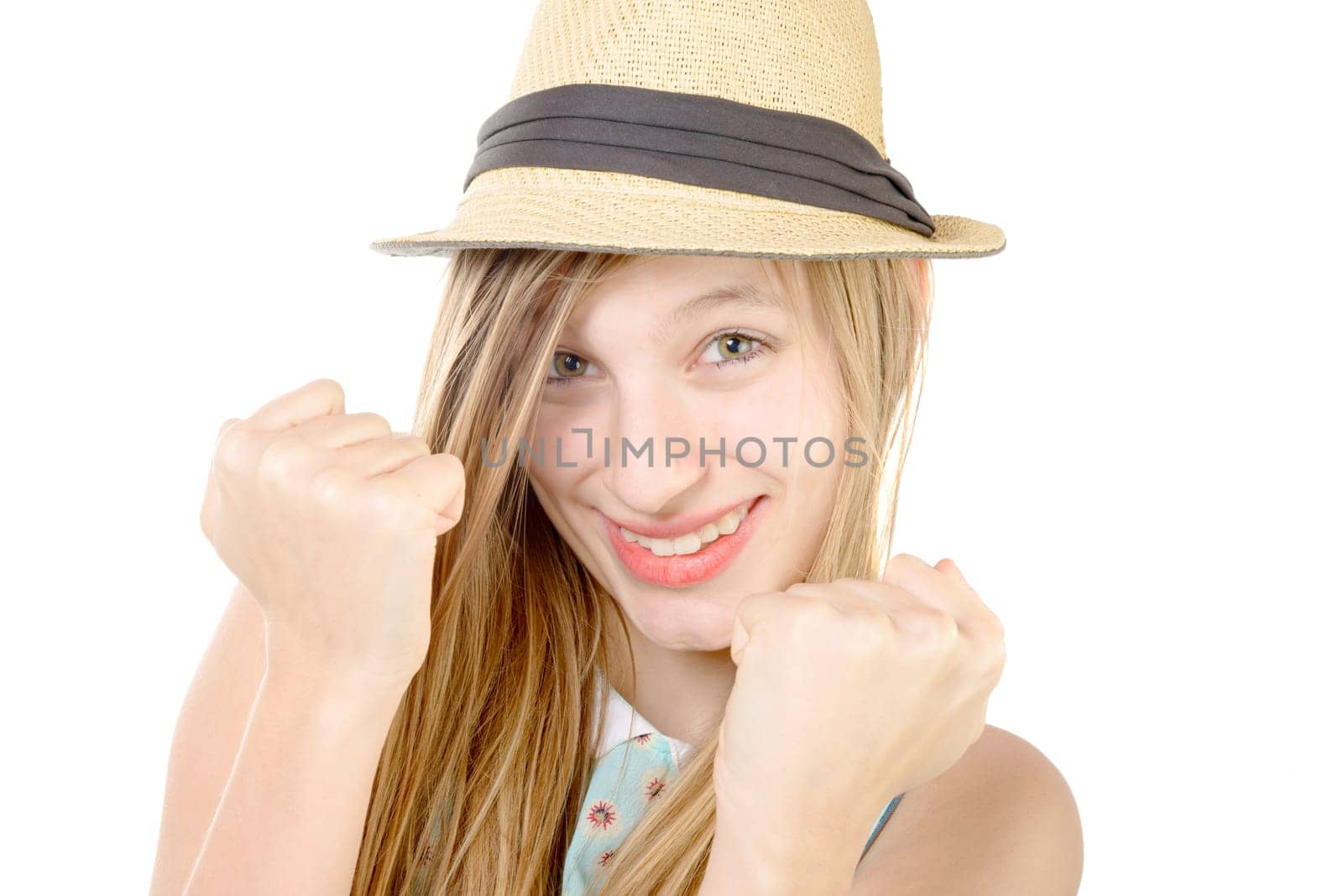 smiling teenager showing fists on white background