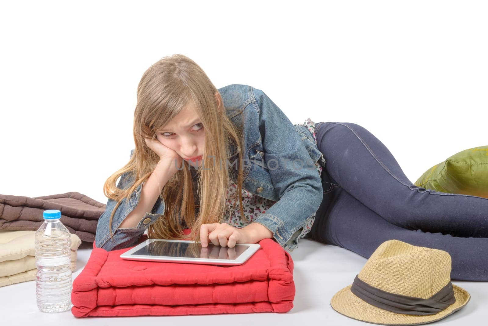 teenager with a digital tablet is angry on a white background