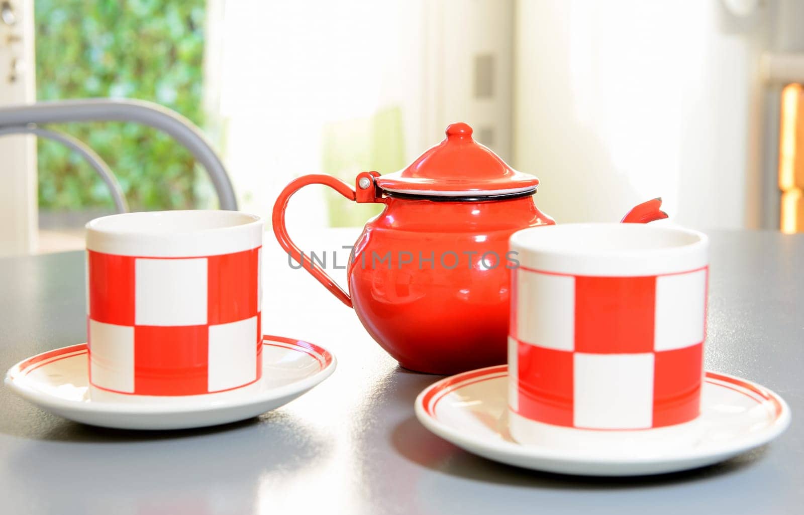 teapot and tea cups on a table painted in gray