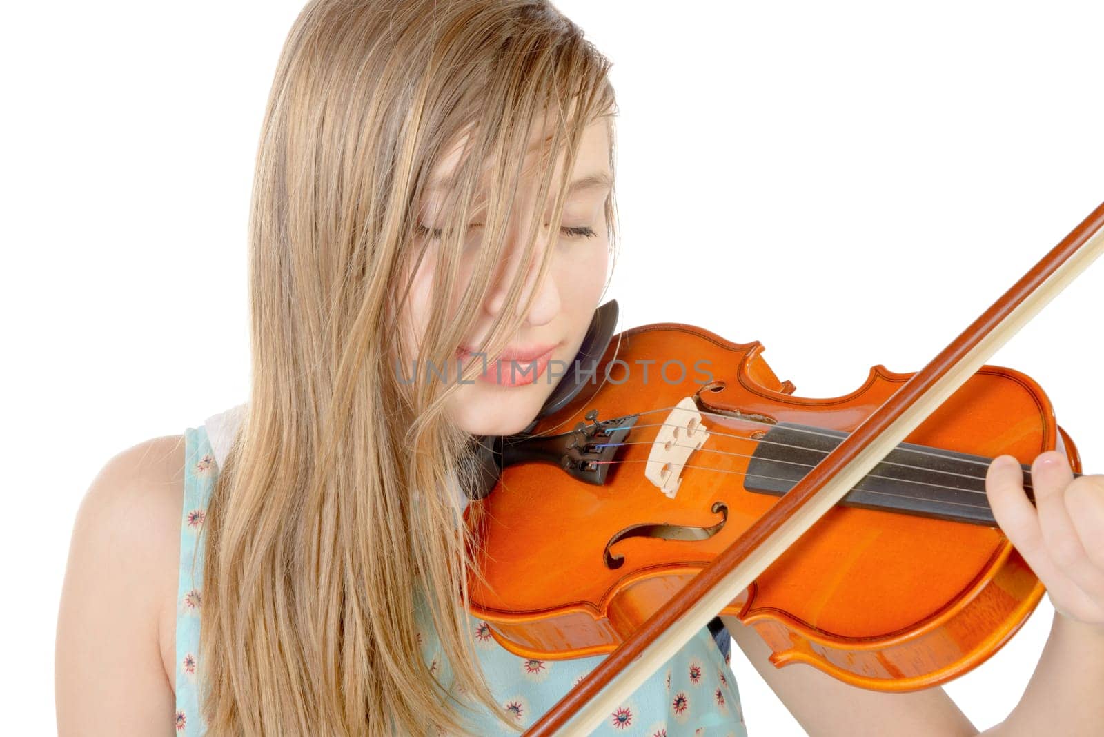 a teenage girl with long hair plays violin on the white background
