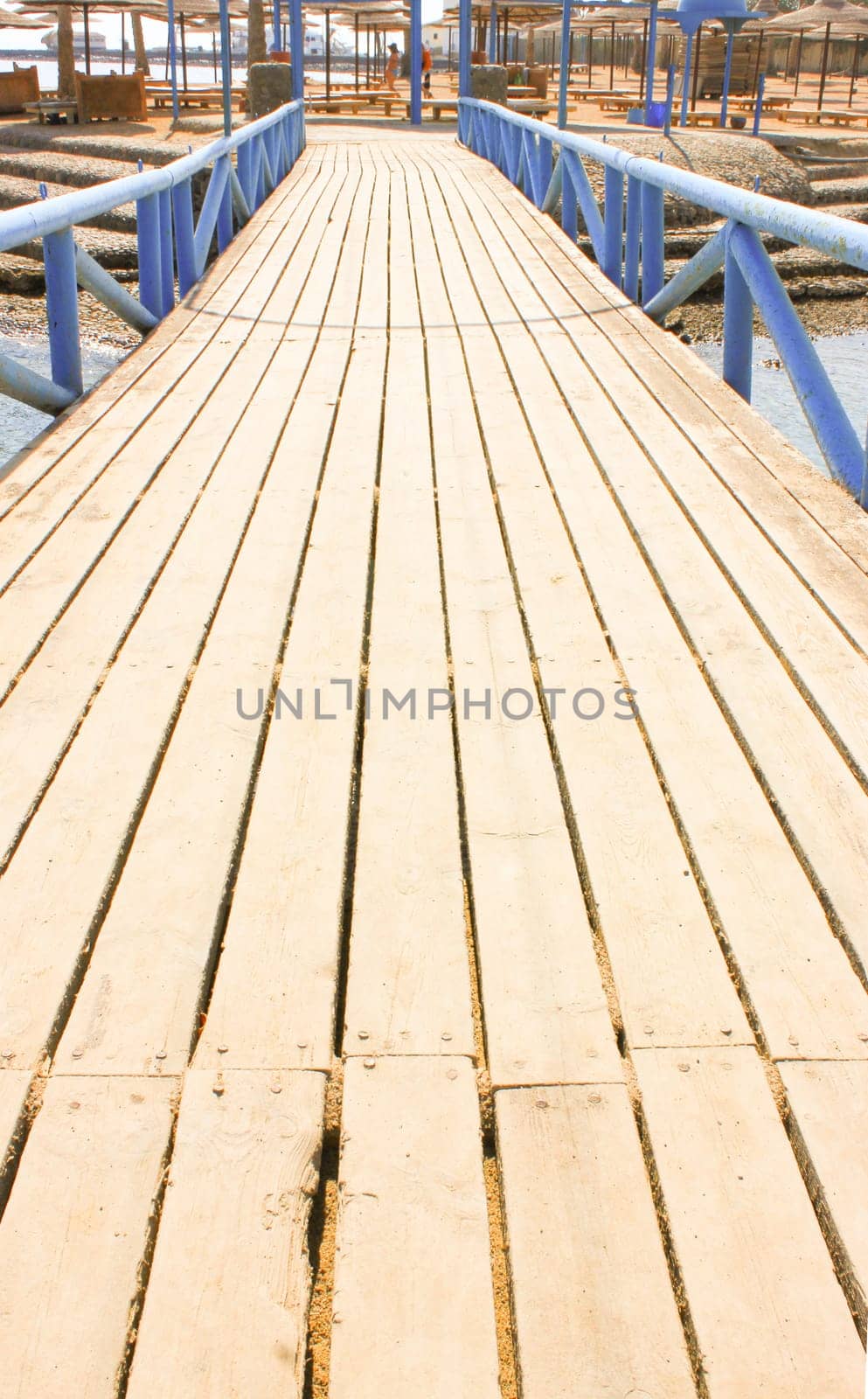 Wooden bridge on the beach shore.
