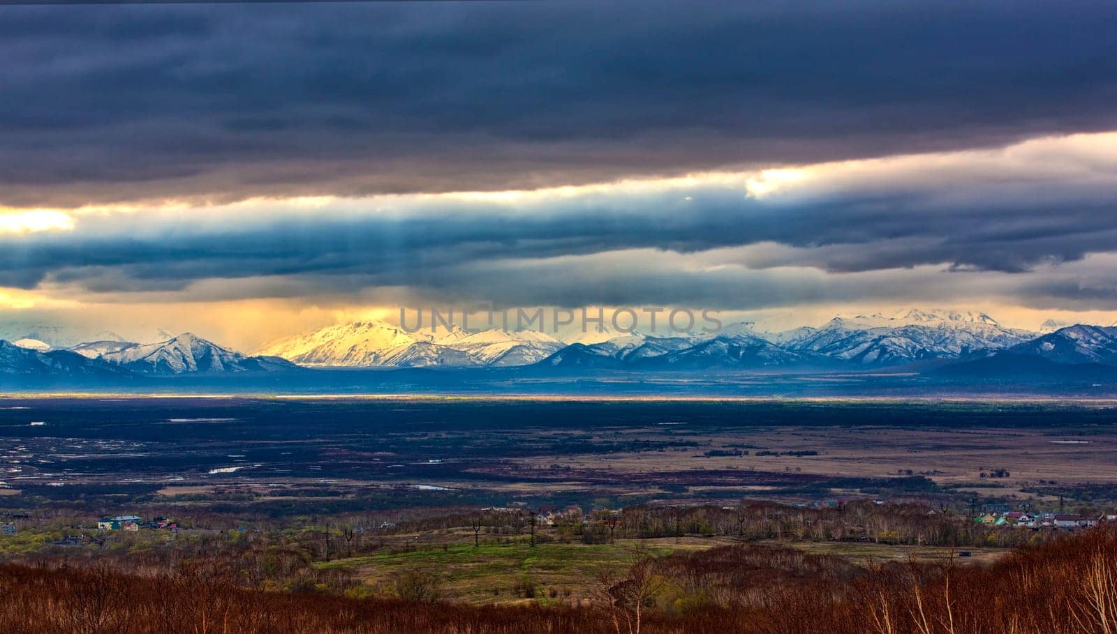 The snowy mountains and storm clouds autumn on Kamchatka