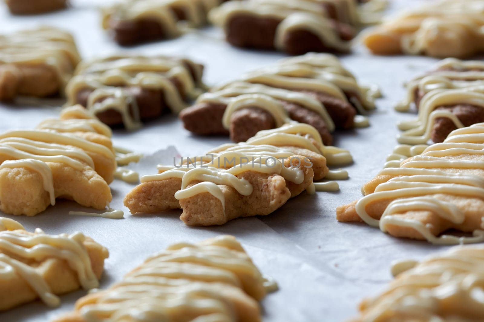 Pouring chocolate on just baked christmas cookies