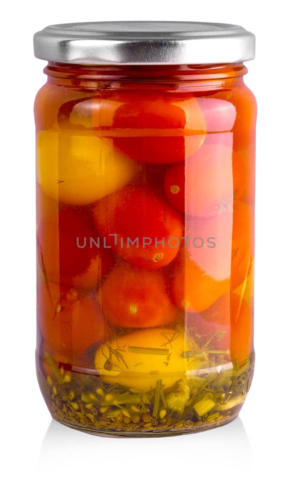 Pickled red and yellow tomato in glass isolated on white background.