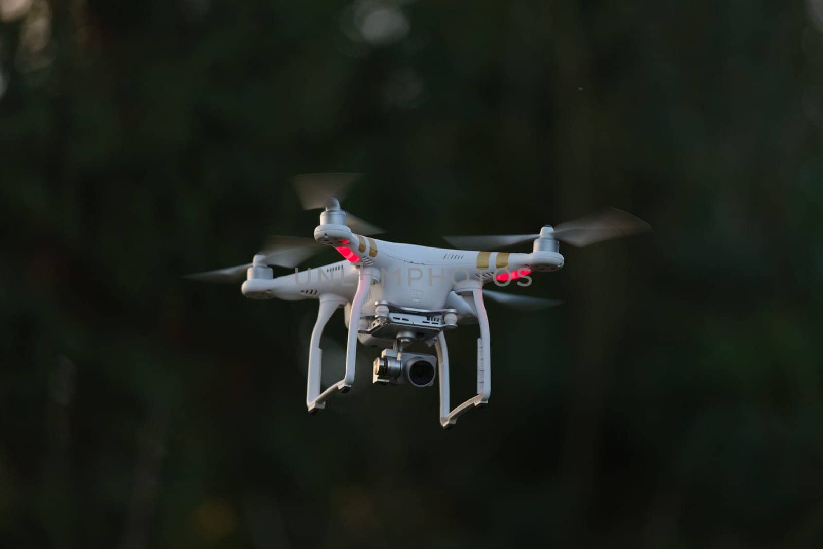 8 - UAV drone copter flying, isolated against plain background. Modern technology in action, used for videography and photography.
