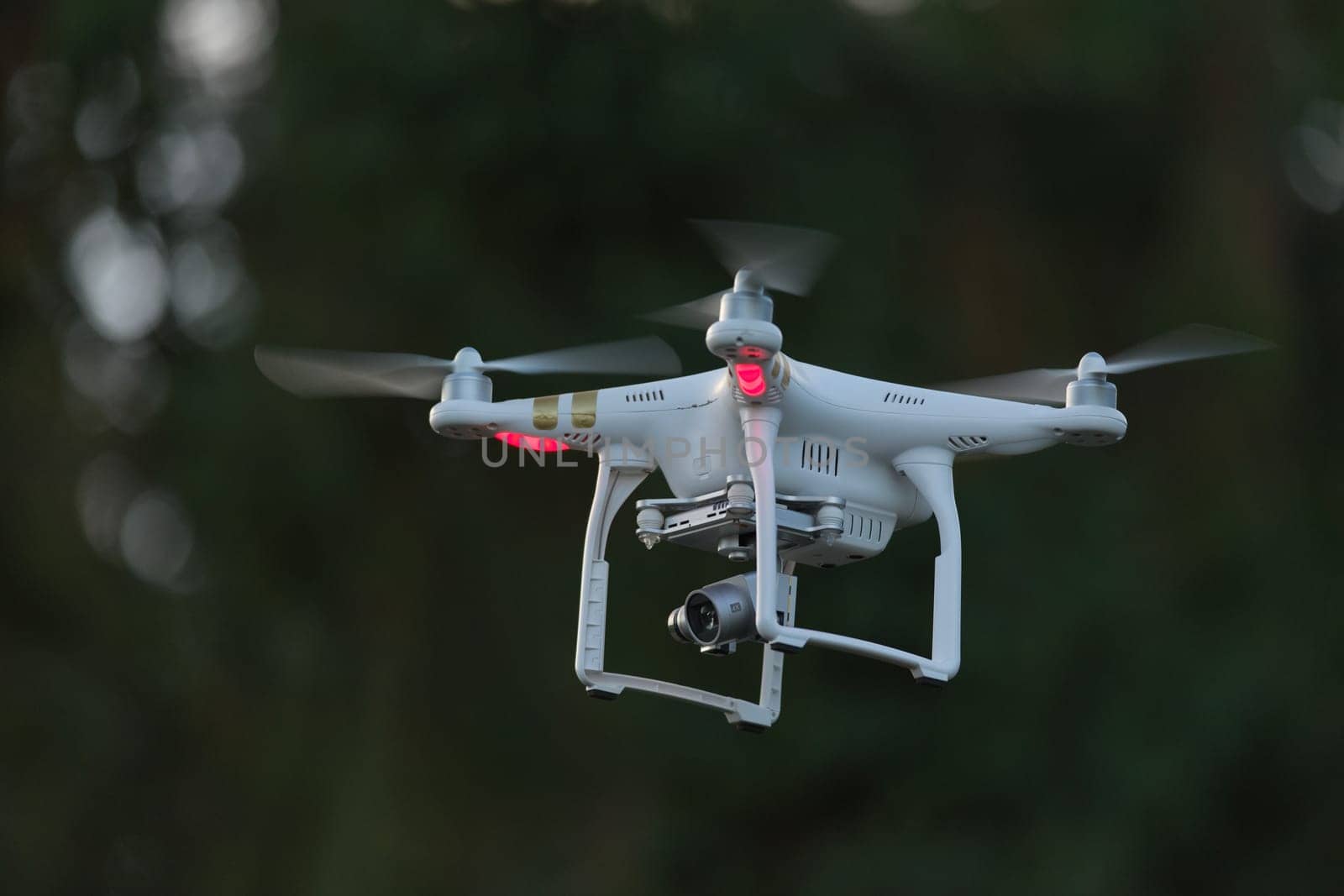 18 - Side view of professional camera drone for videography. 4 sets of propellers as its a quadcopter, controlled by radio link and also by FPV video