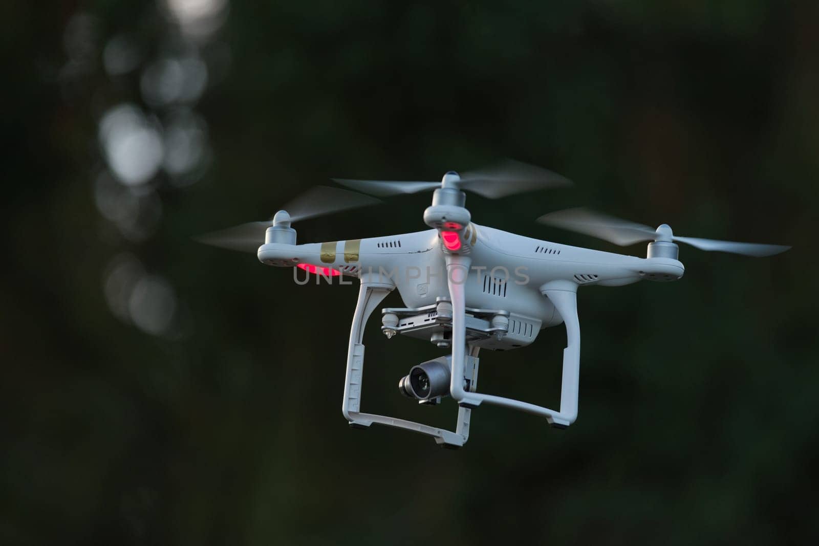 19 - UAV remote controlled commercial quad copter drone hovering. Hobby aircraft with professional imaging applications.