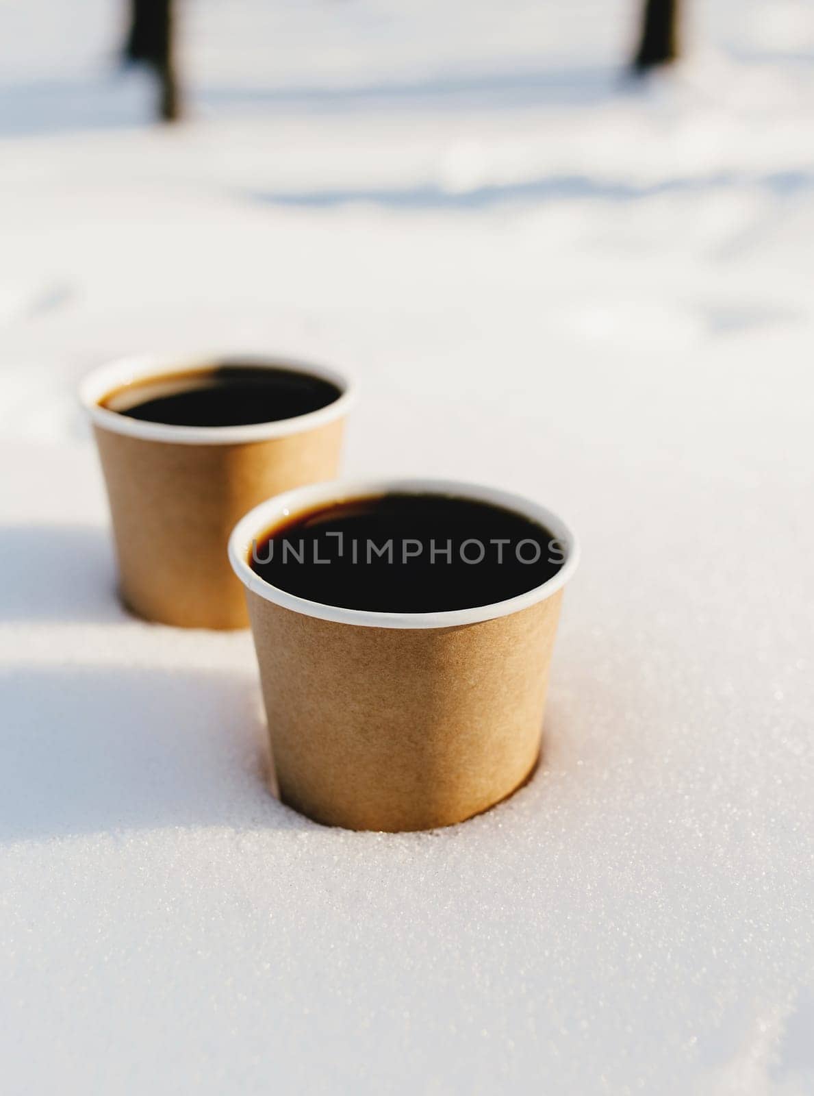 Two cups of coffee in the snow in the forest. High quality photo