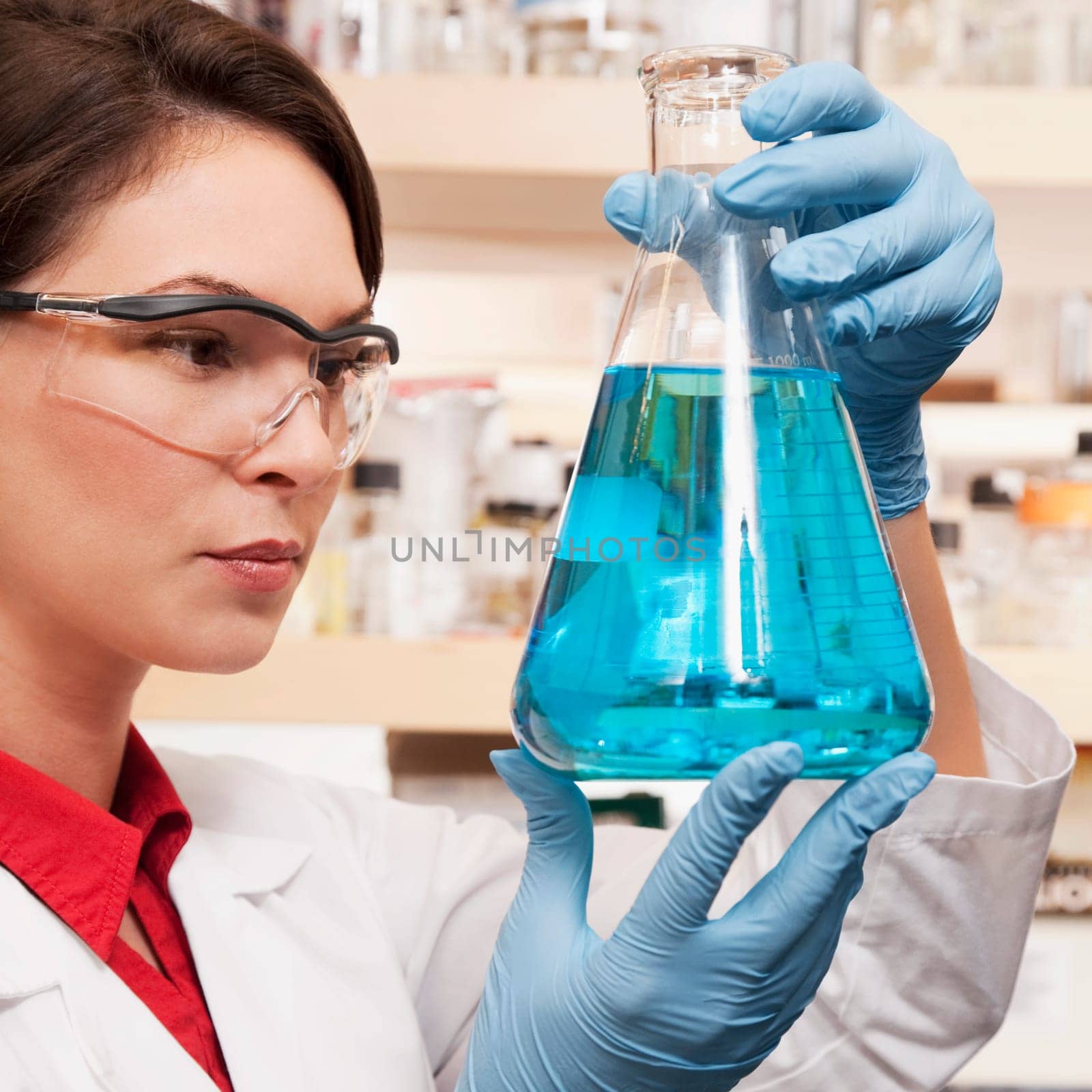 Female doctor holding a conical flask in a laboratory
