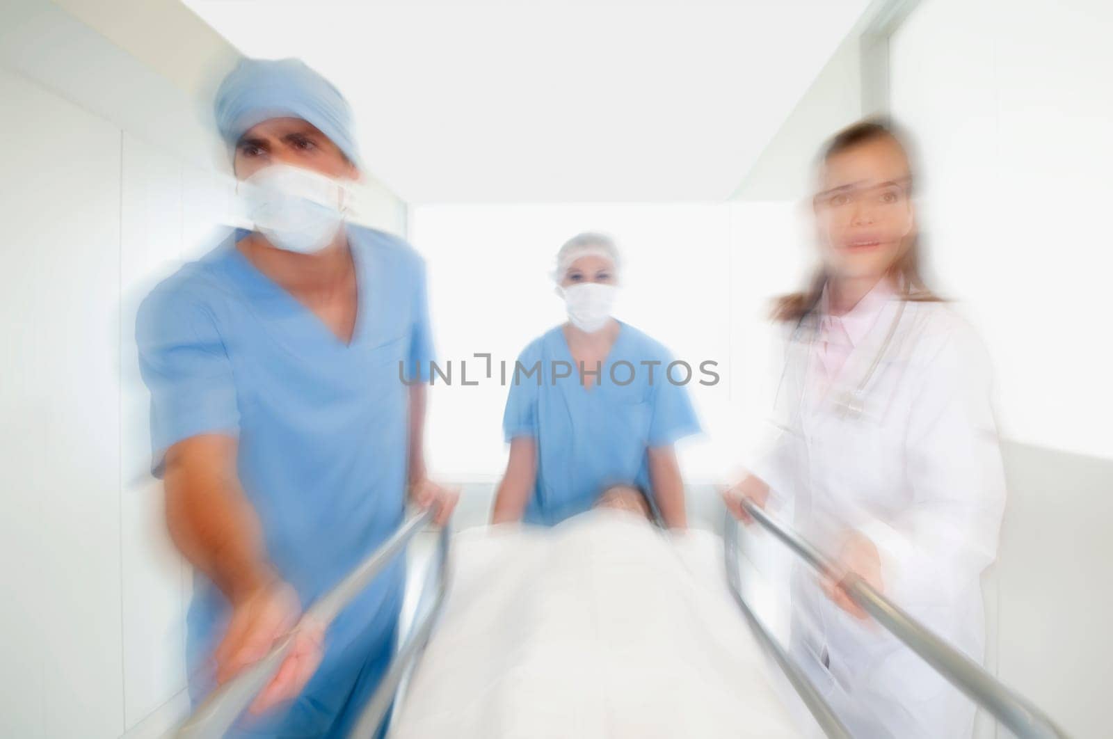Doctors pushing a patient on a hospital Gurney in a hospital corridor