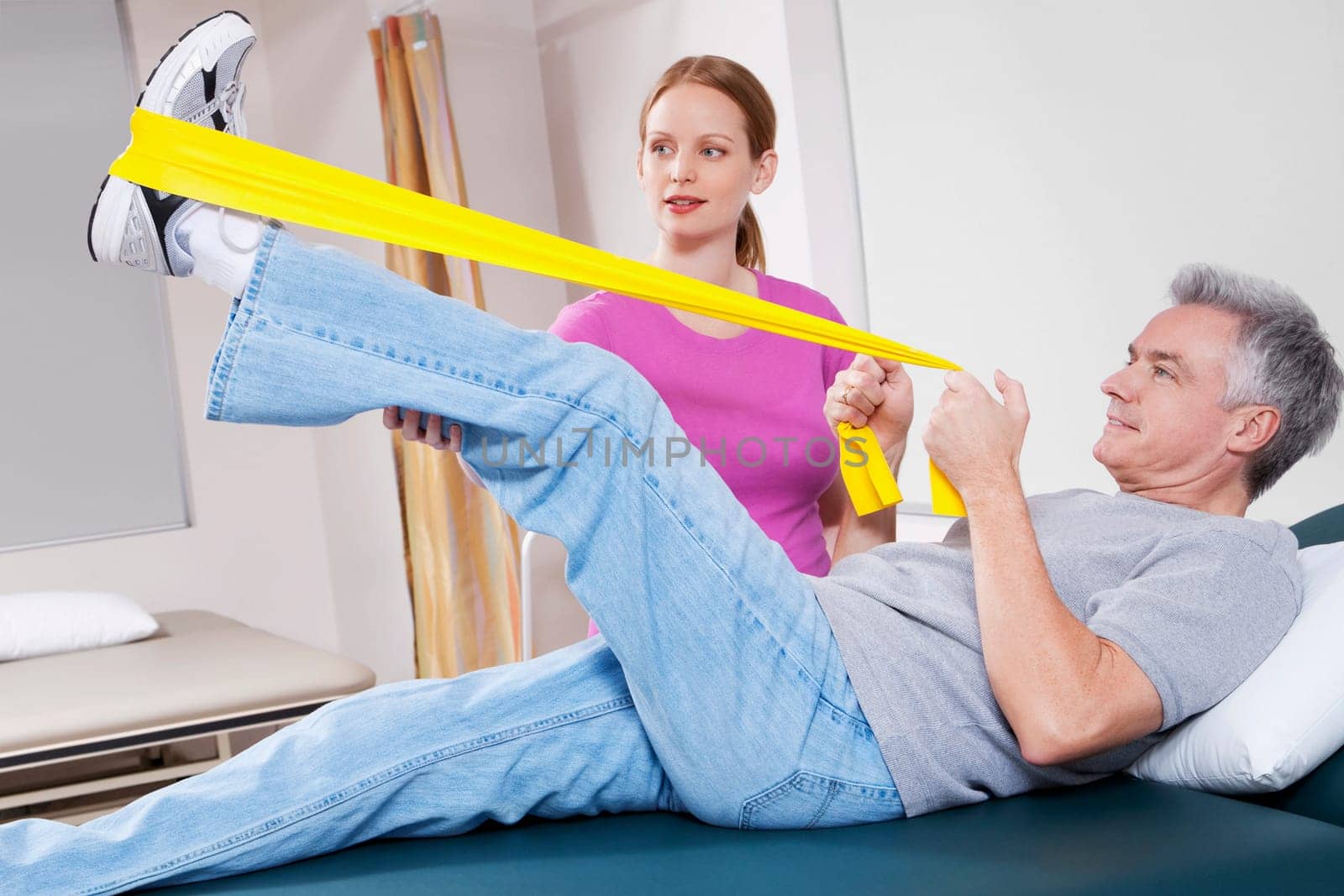 Physiotherapist assisting a patient in exercising