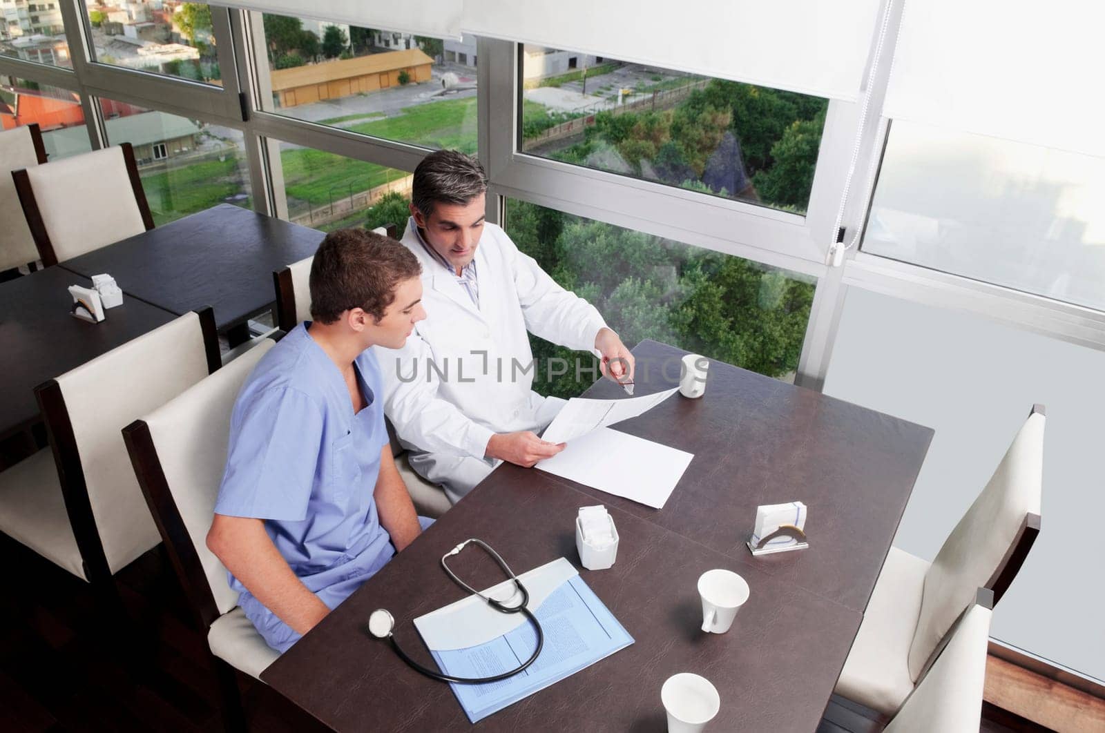 Doctors discussing a medical report in a cafeteria