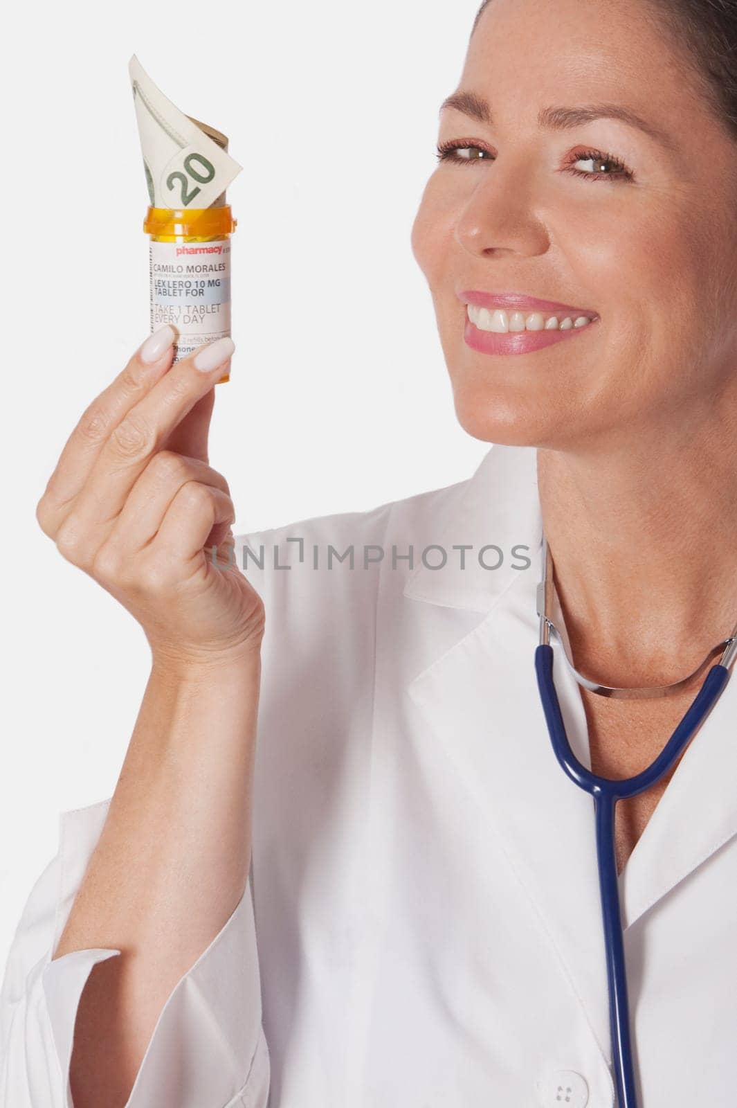 Female doctor holding a pill bottle with currency note