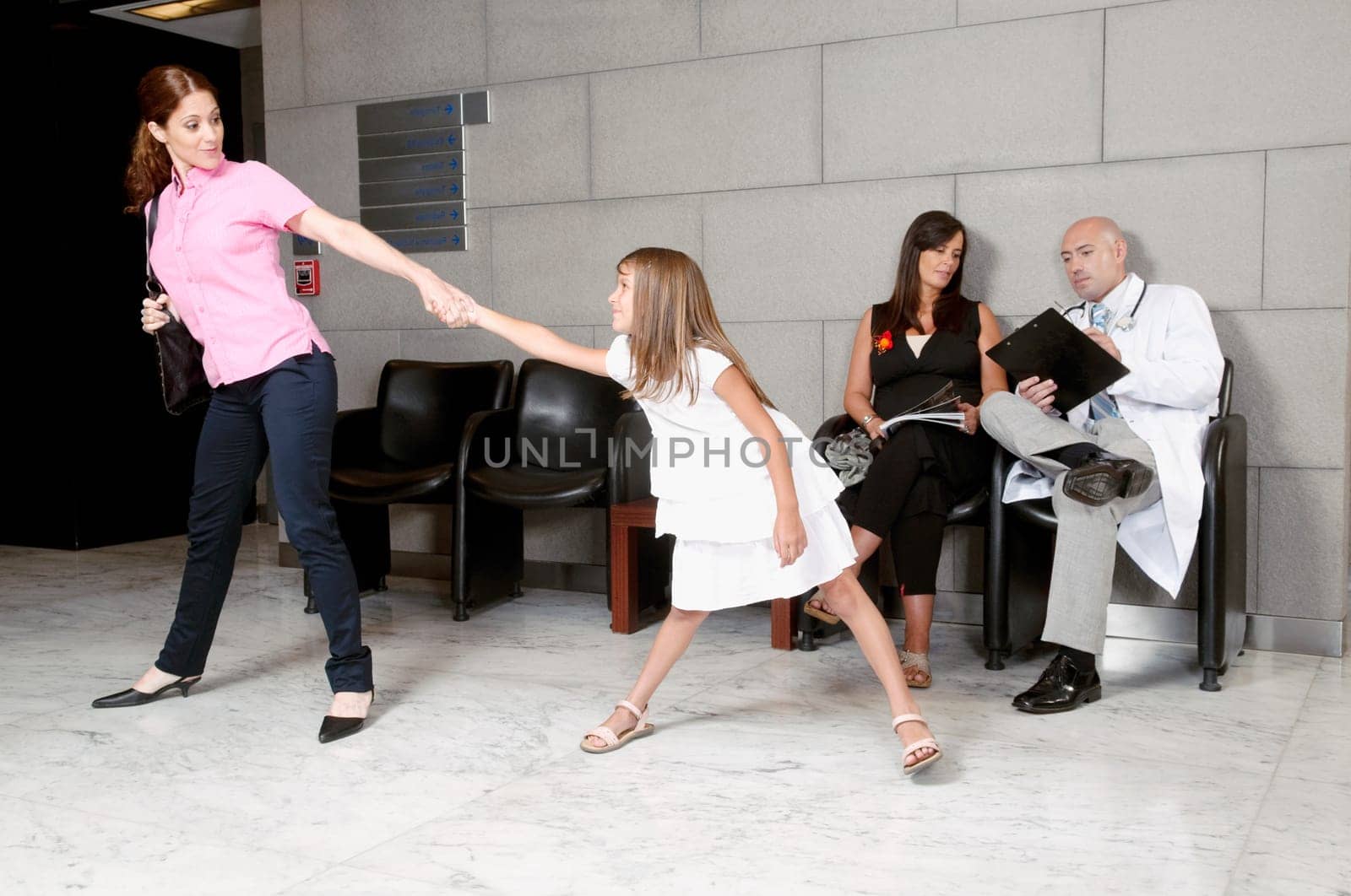 Girl pulling her motherŽs hand in a hospital