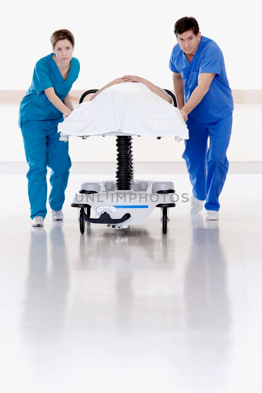 Two doctors pushing patient on a gurney