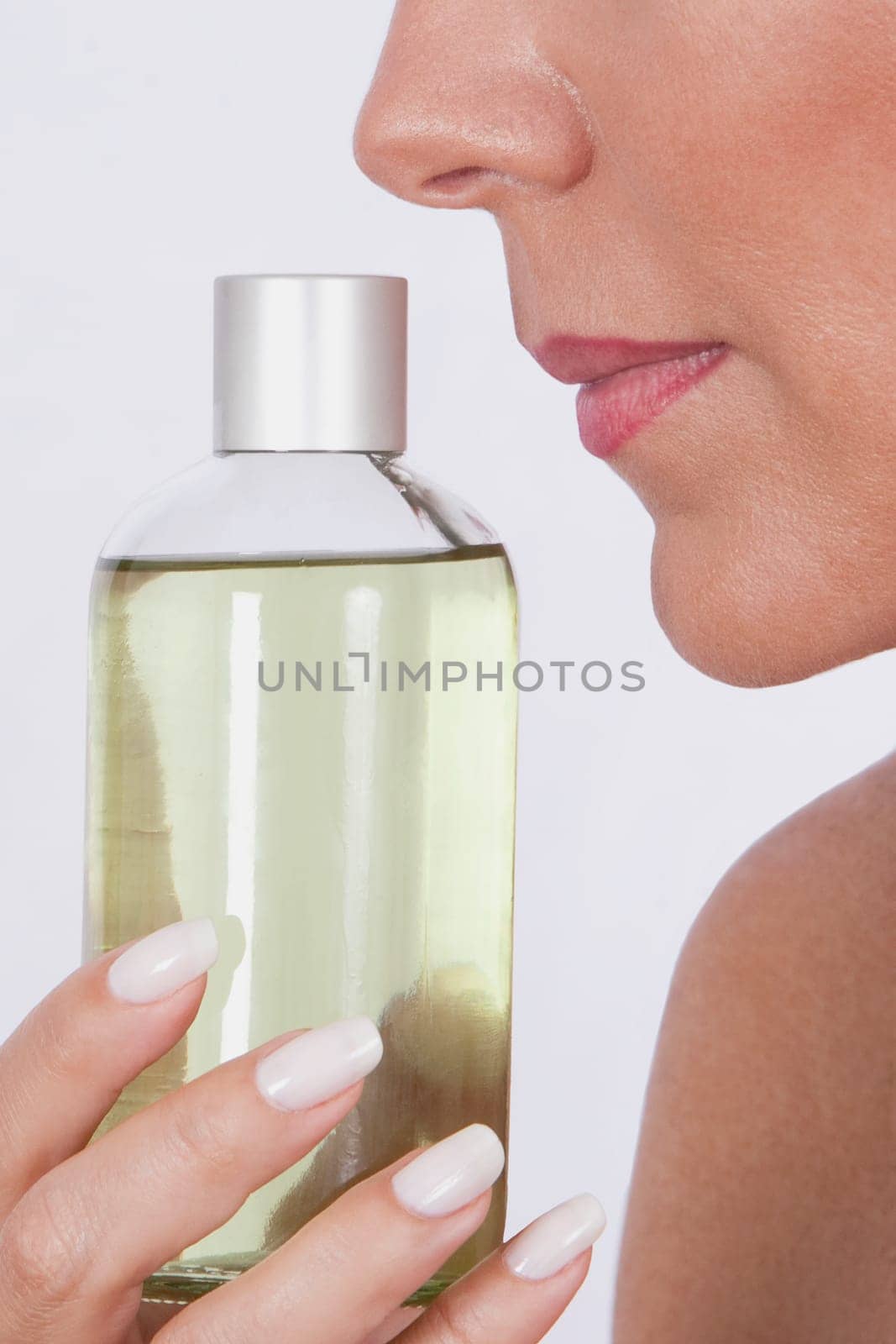 Woman smelling aromatherapy oil
