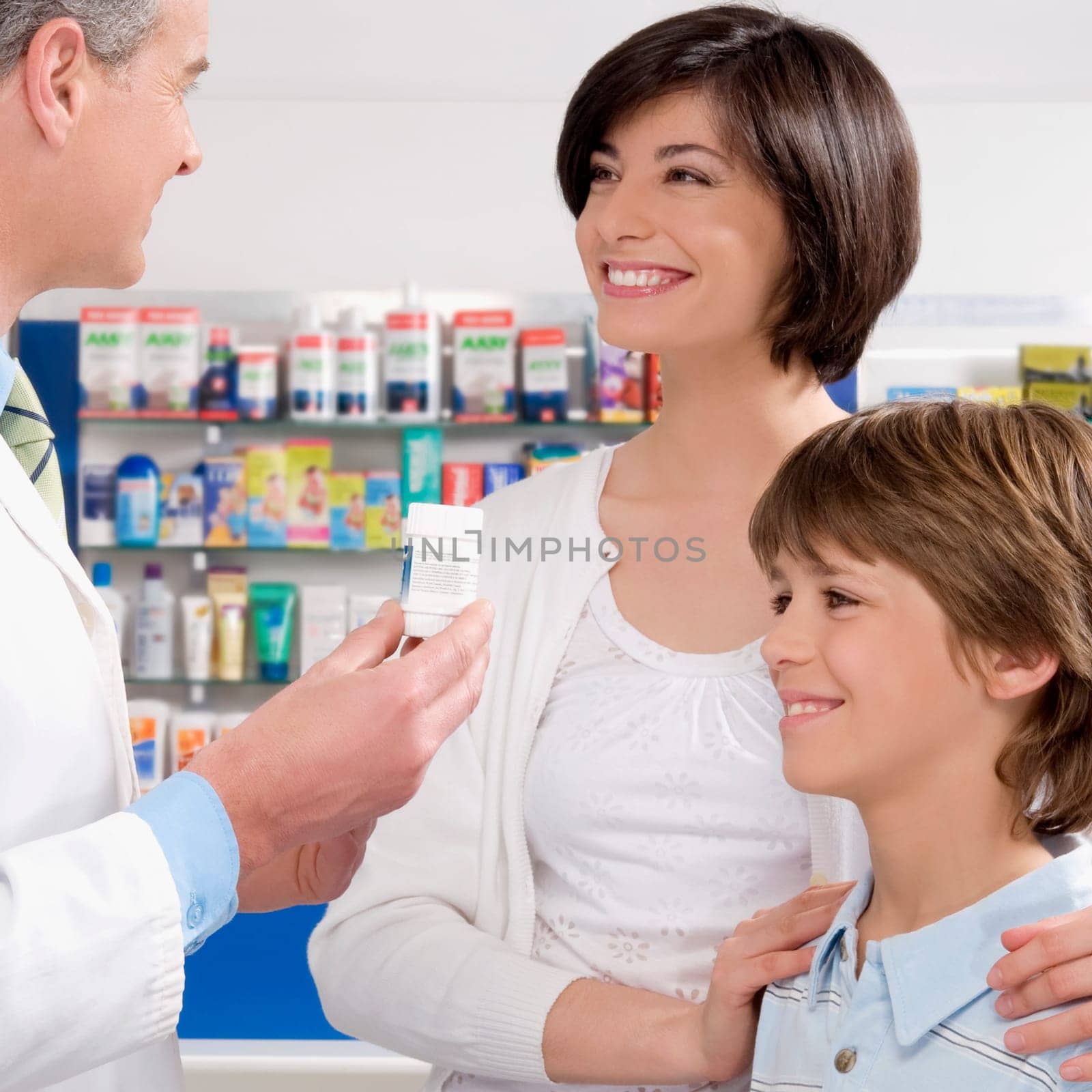 Male pharmacist giving medicine to customers