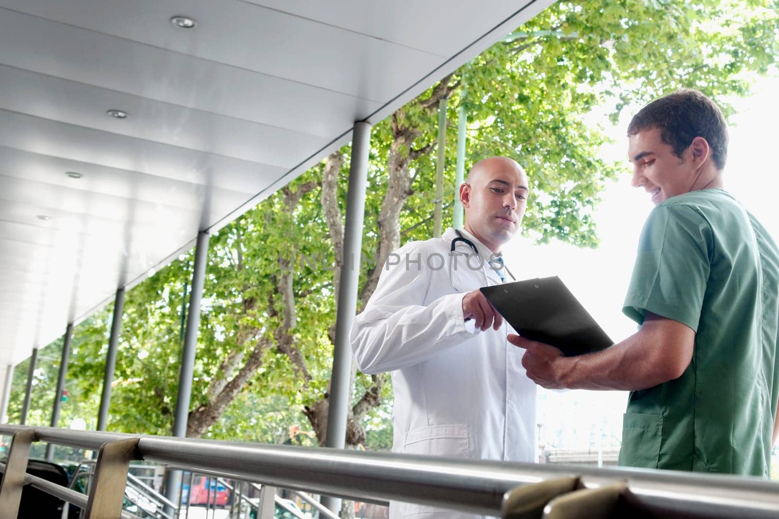 Doctor talking to a male nurse