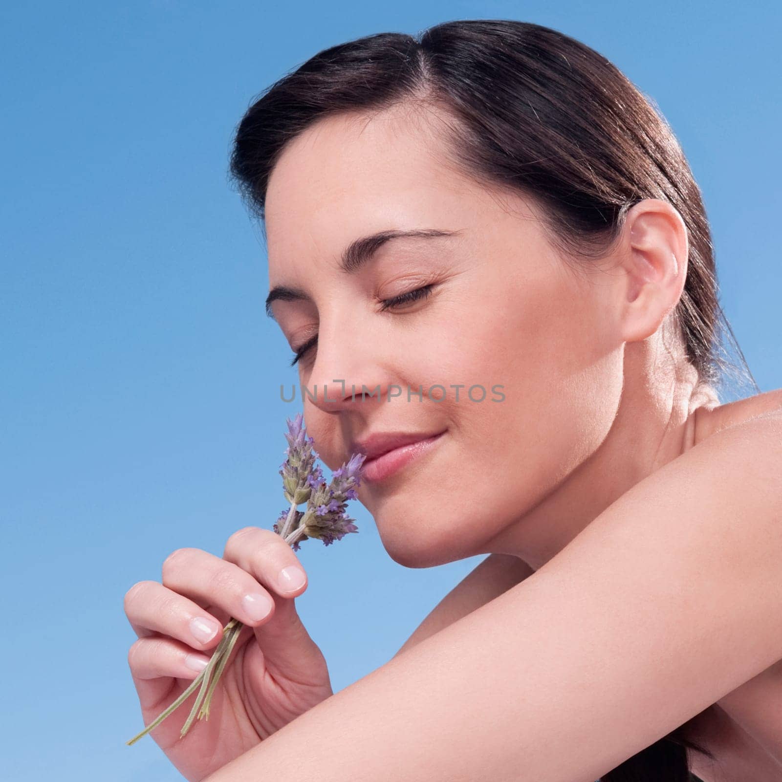 Close_up of a woman smelling lavender flowers