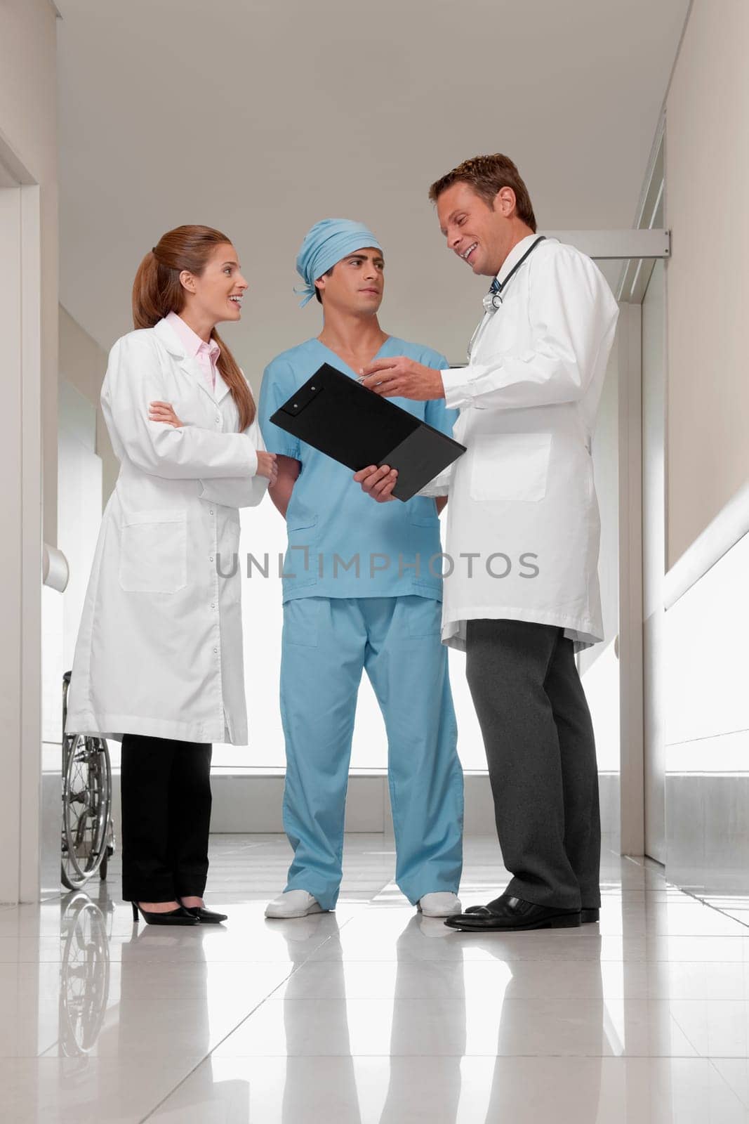 Three doctors discussing in a hospital