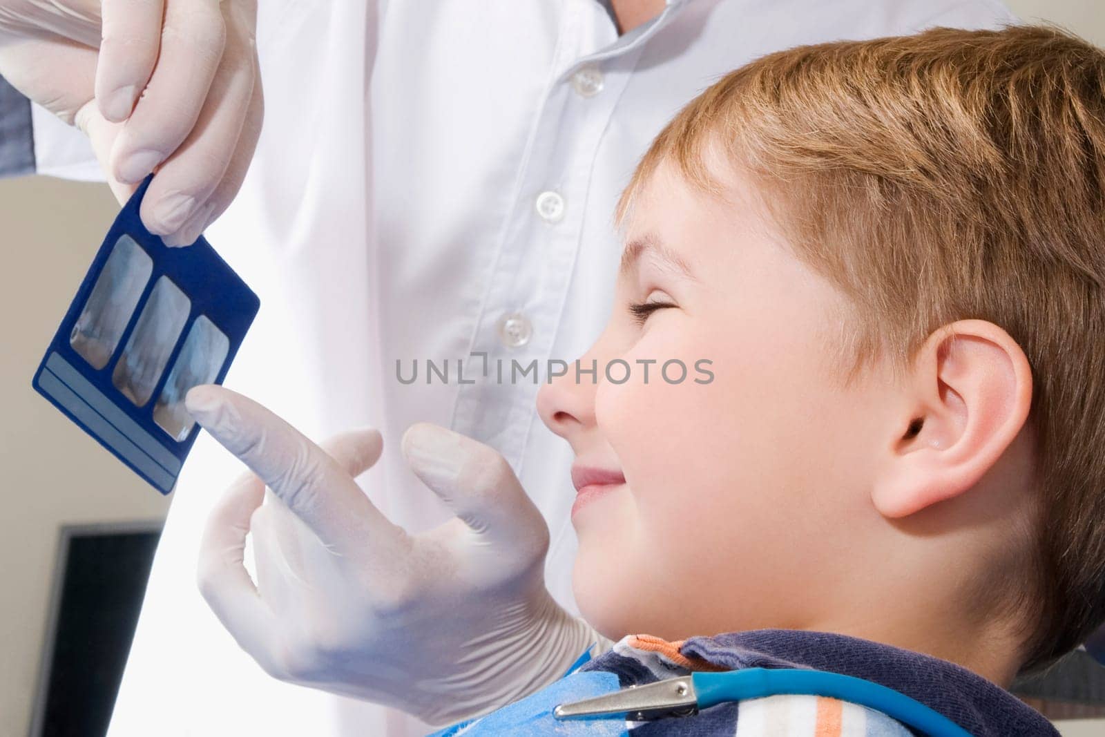 Dentist showing an X_Ray report to a boy