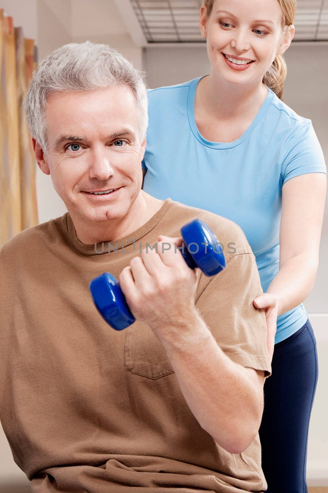 Physiotherapist assisting a patient in exercising