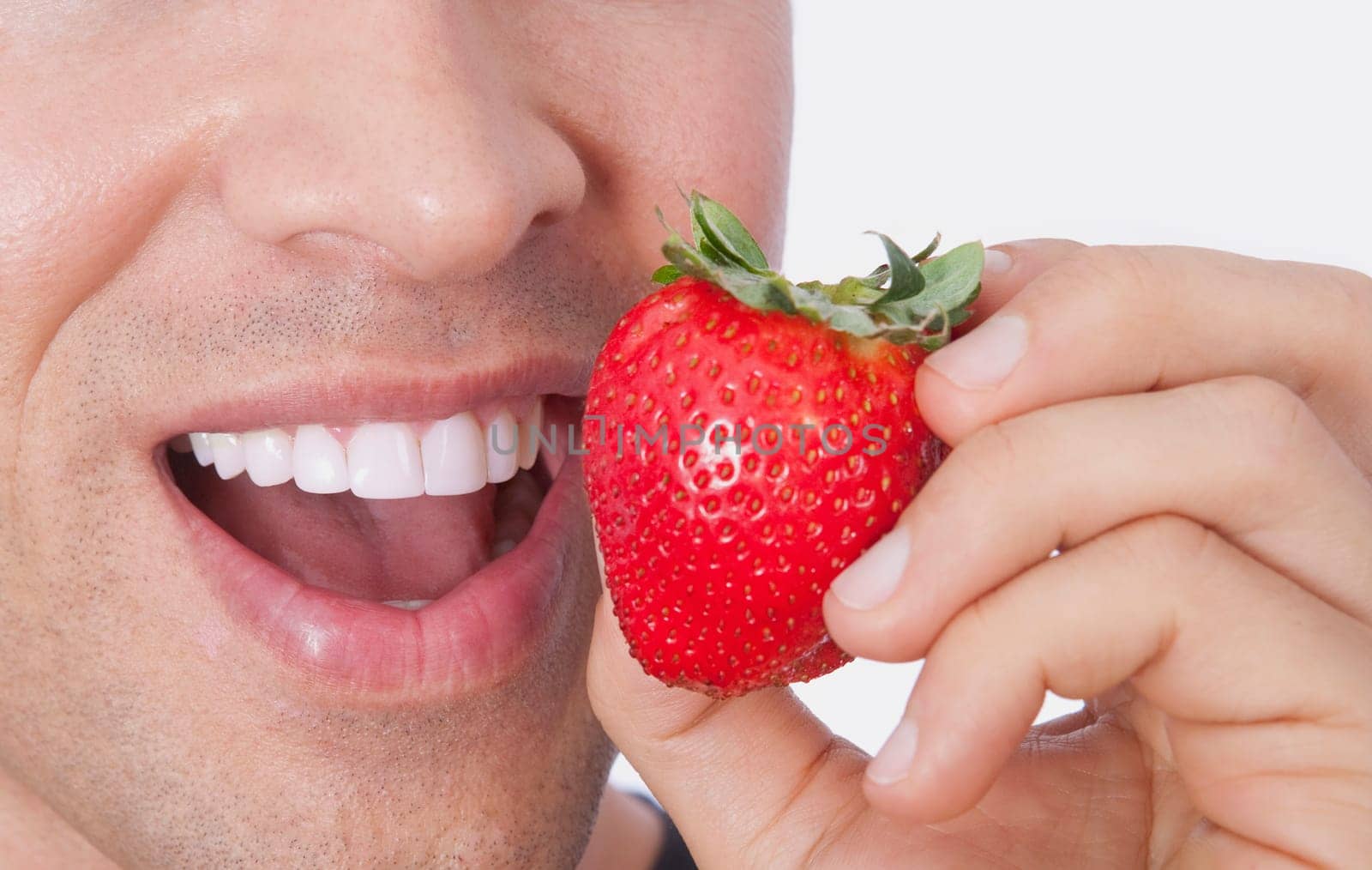 Man eating a strawberry