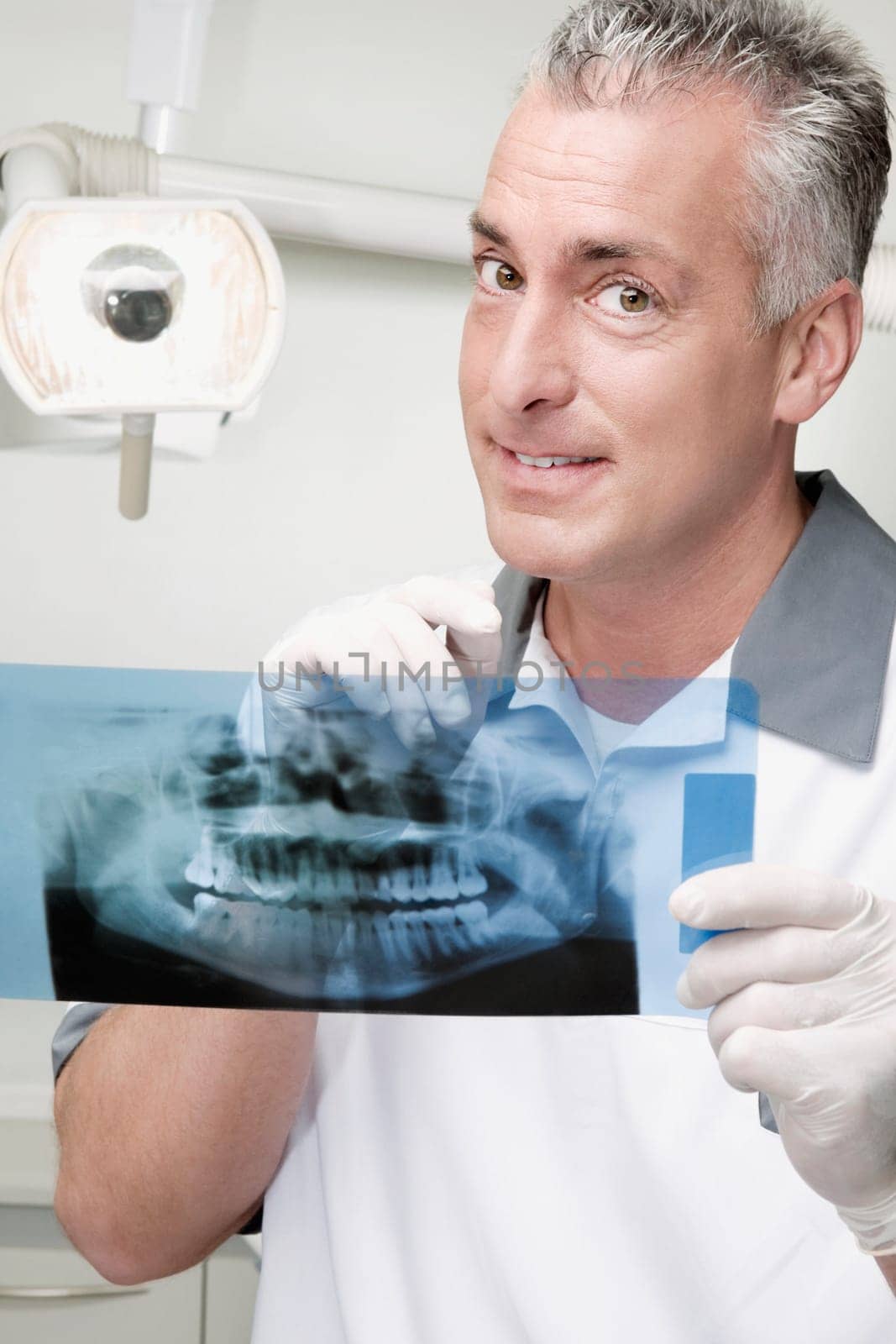 Dentist examining an X_Ray report